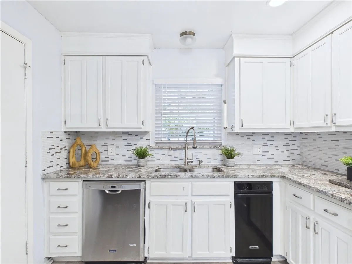 White kitchen cabinetry with window looking to the front of home