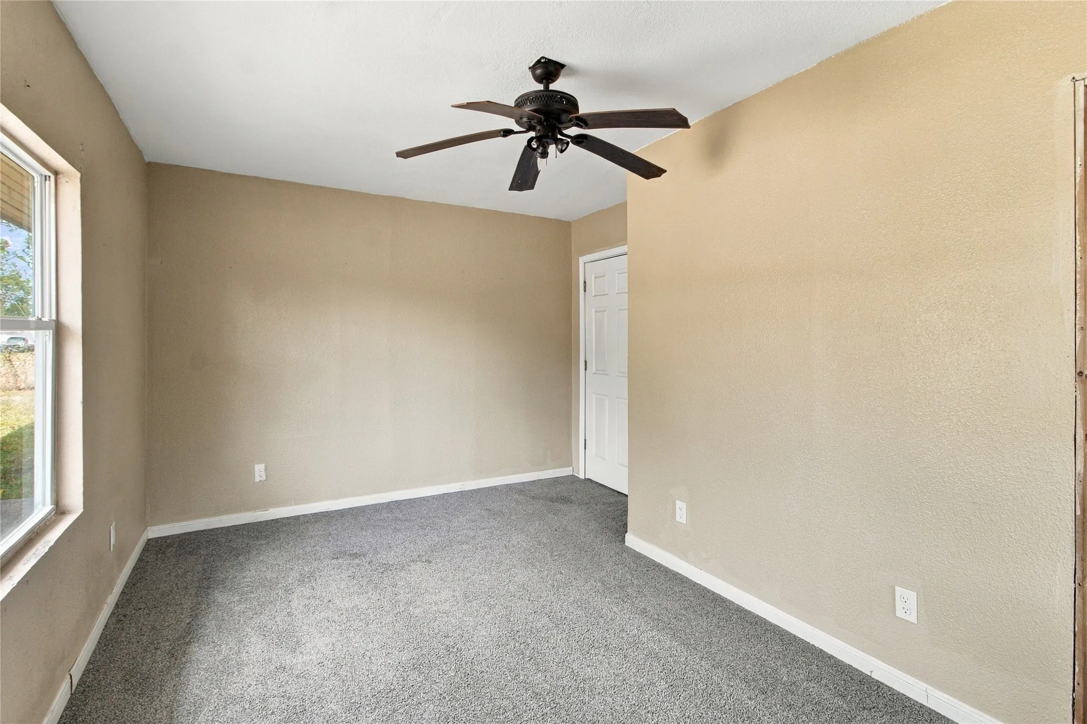 Textured tan walls with carpet flooring