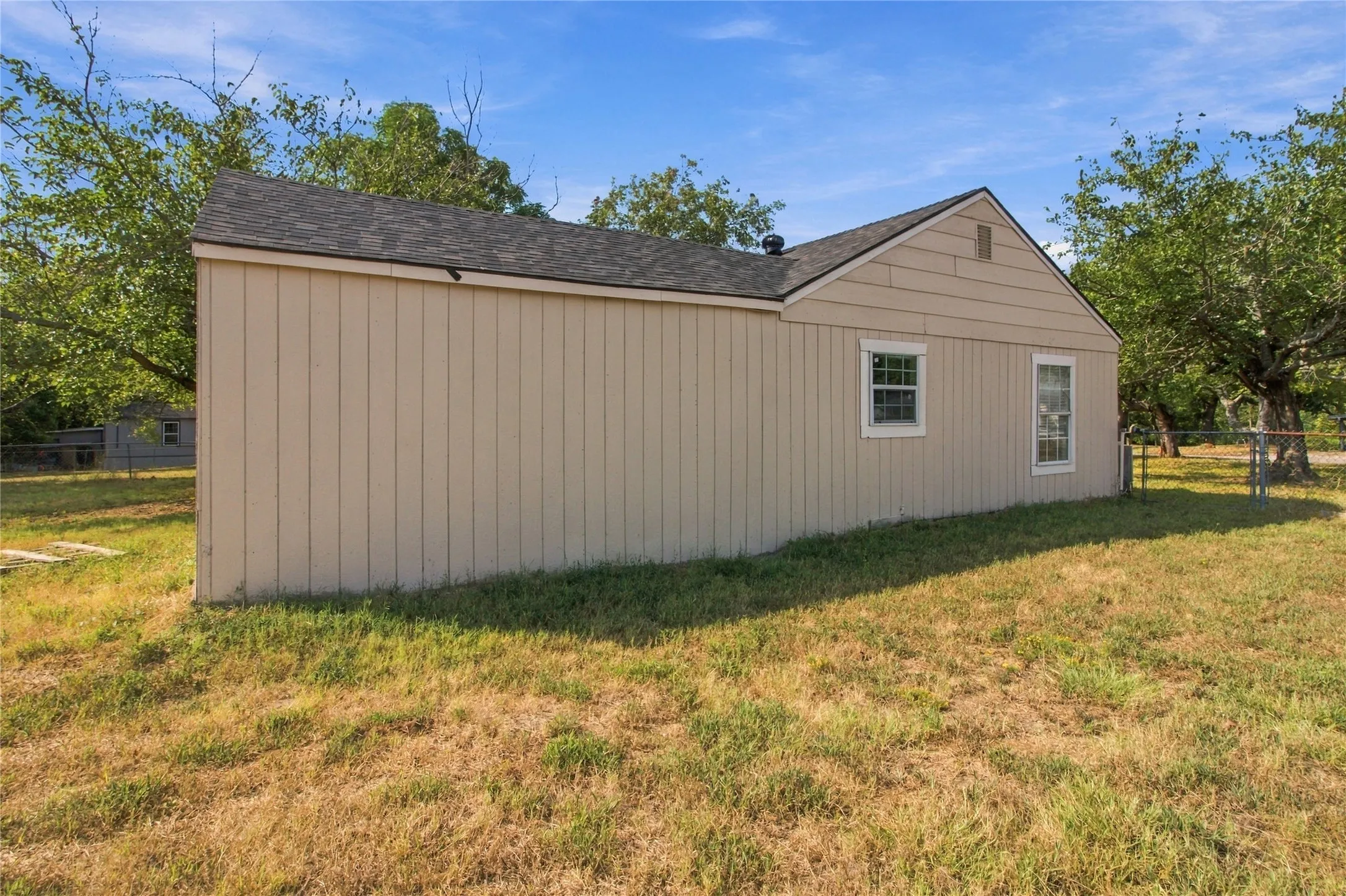 Gable roof with asphalt shingles and beige siding
