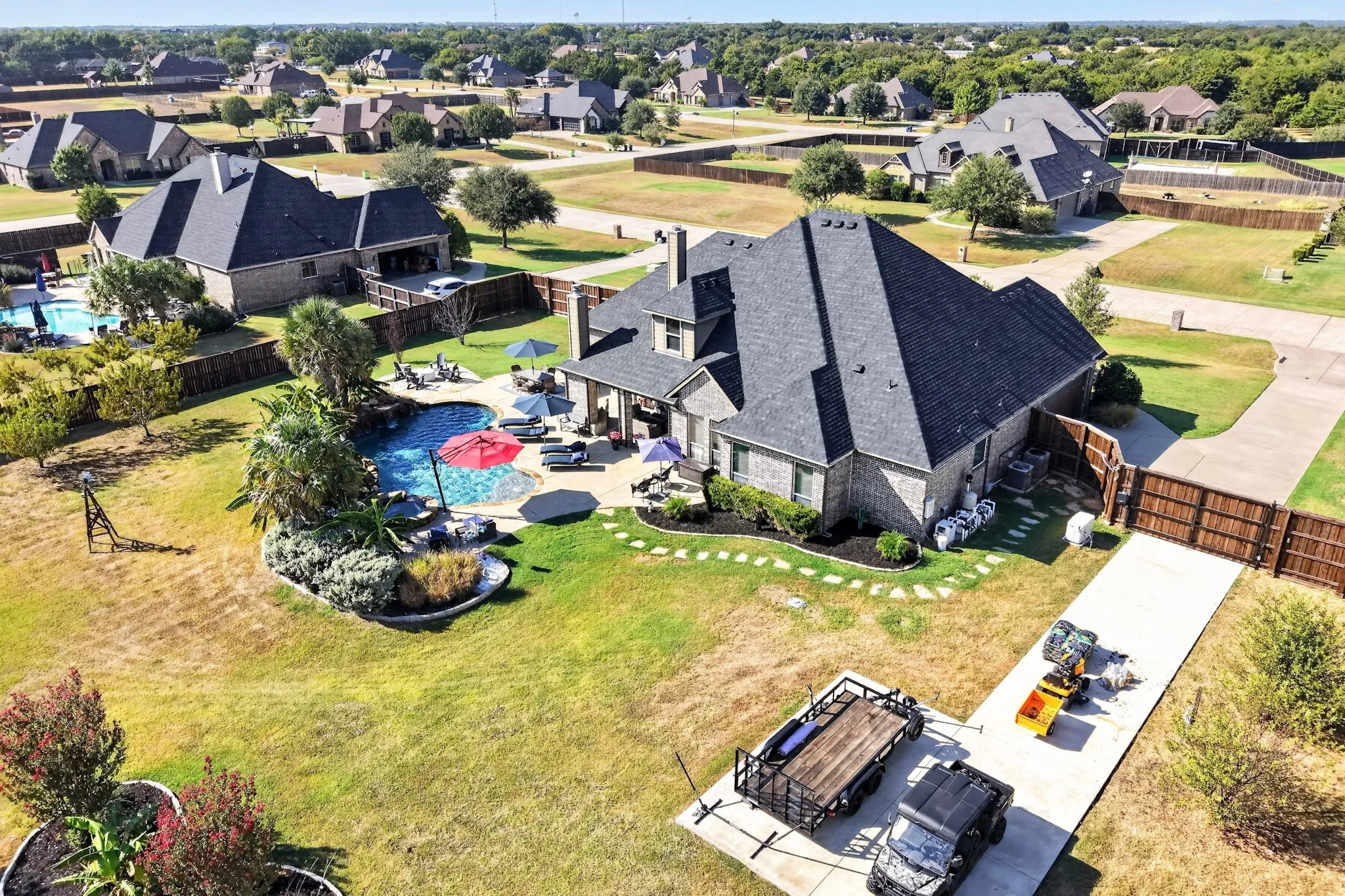 Brick exterior residence with a dark shingle roof