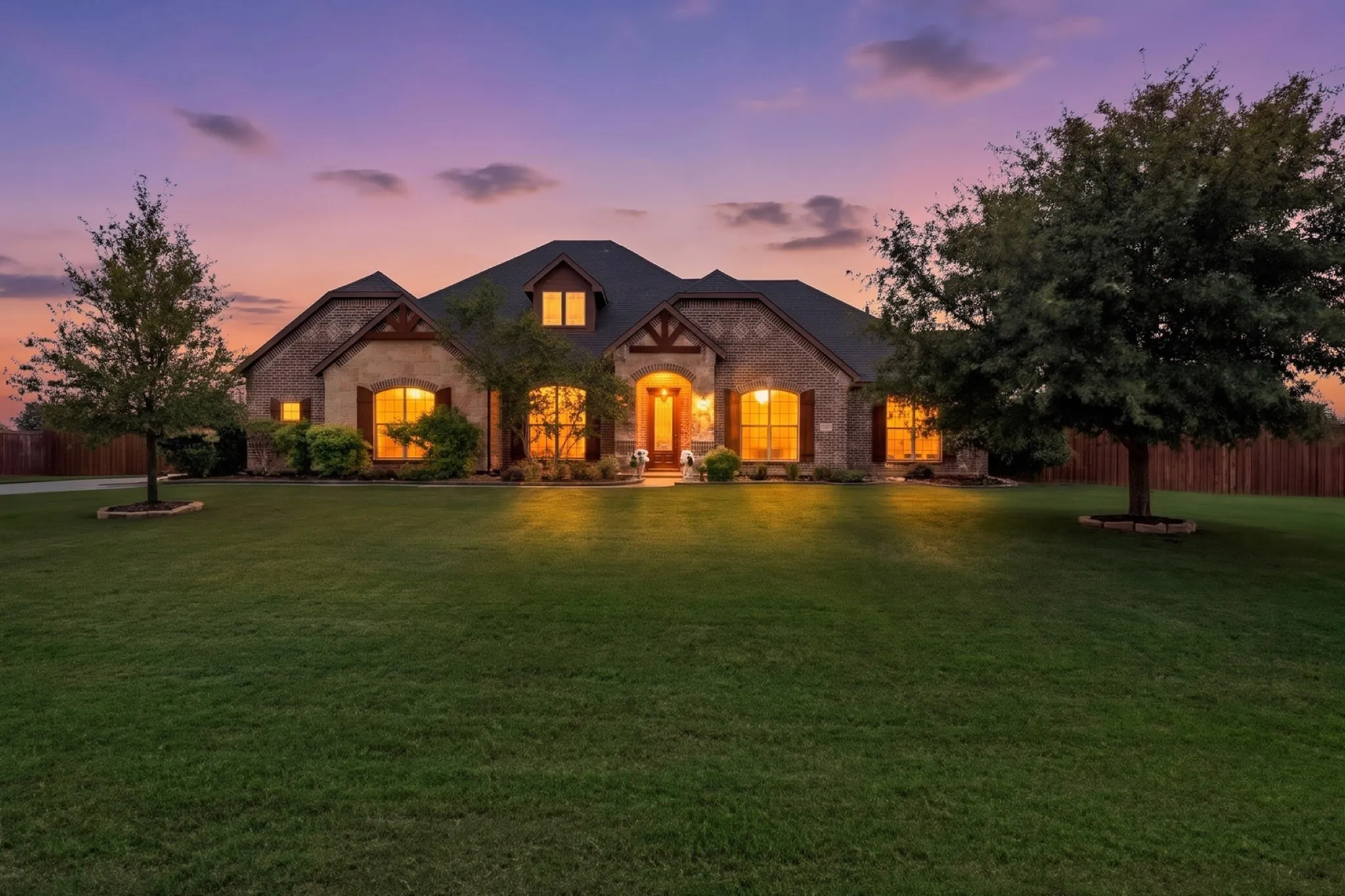 Brick and stone exterior with dark roof shingles