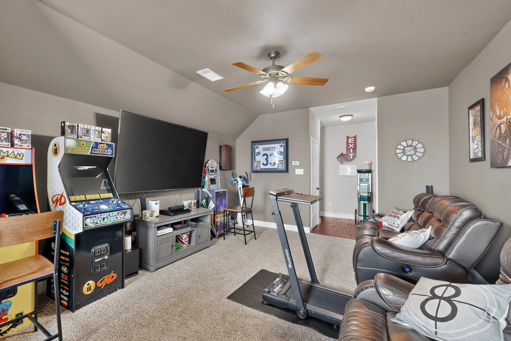Carpeted room with a ceiling fan, recessed lighting, and sloped ceilings