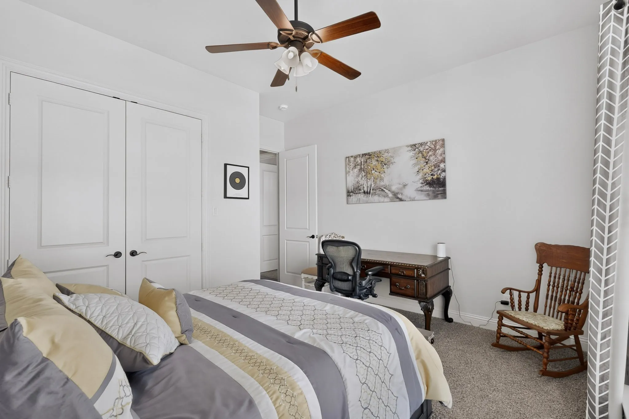 Recessed ceiling lighting, ceiling fan with light kit, white interior doors with dark hardware, and neutral wall tones
