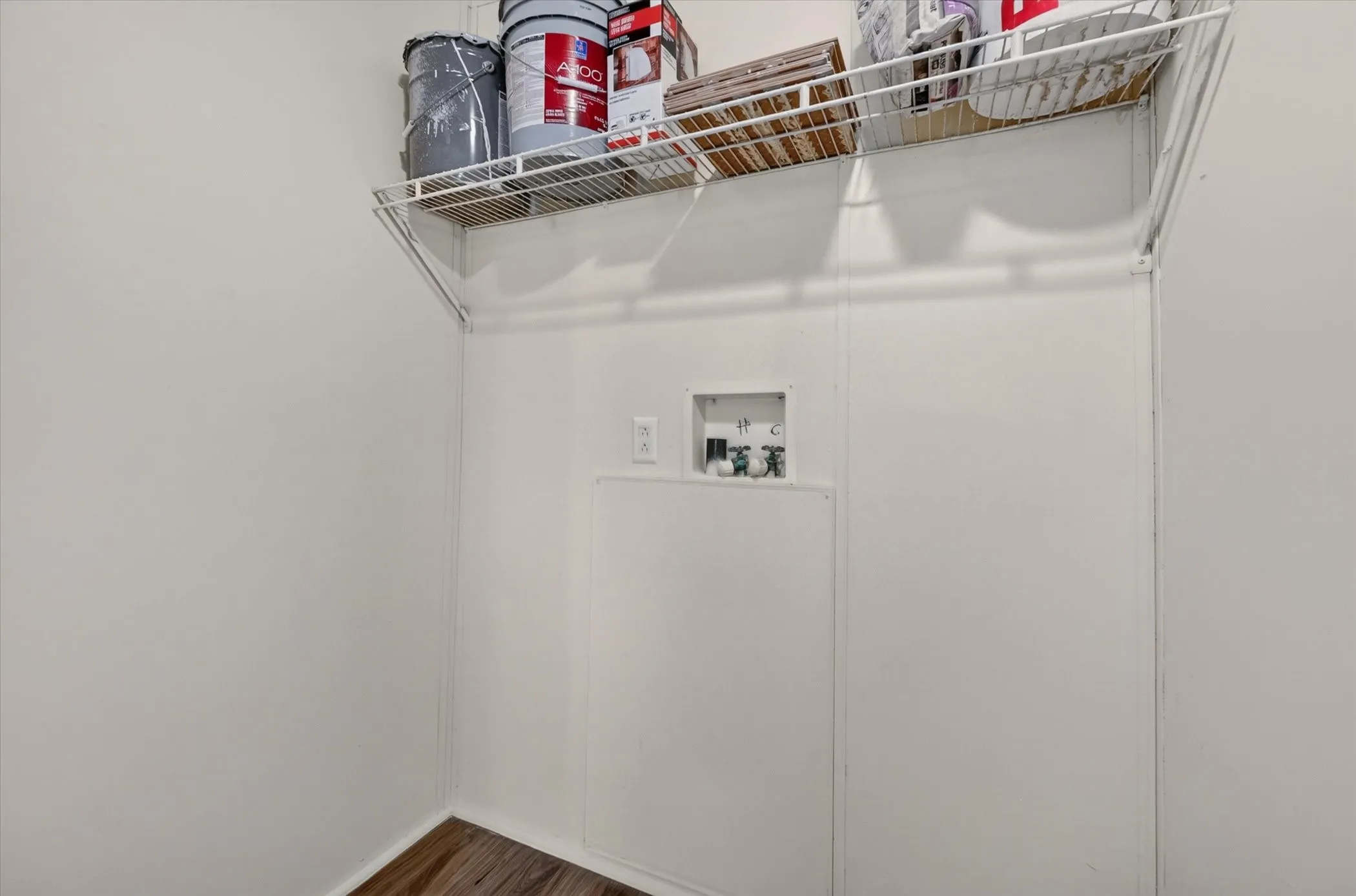 Wood-finish flooring with white wall paneling