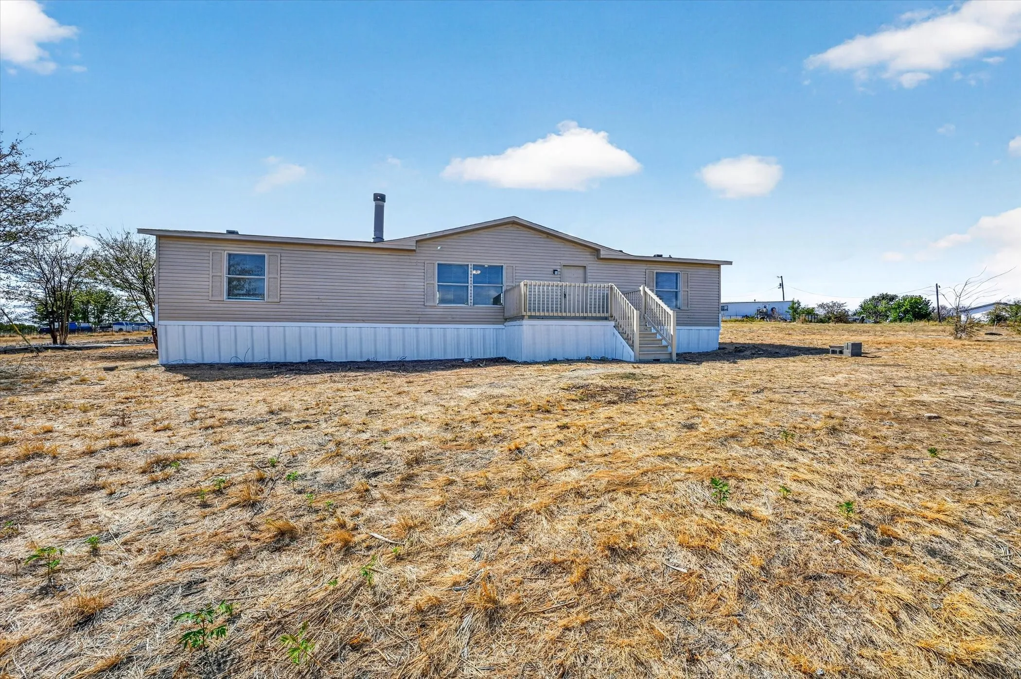 Ranch-style residence featuring neutral siding and white skirting