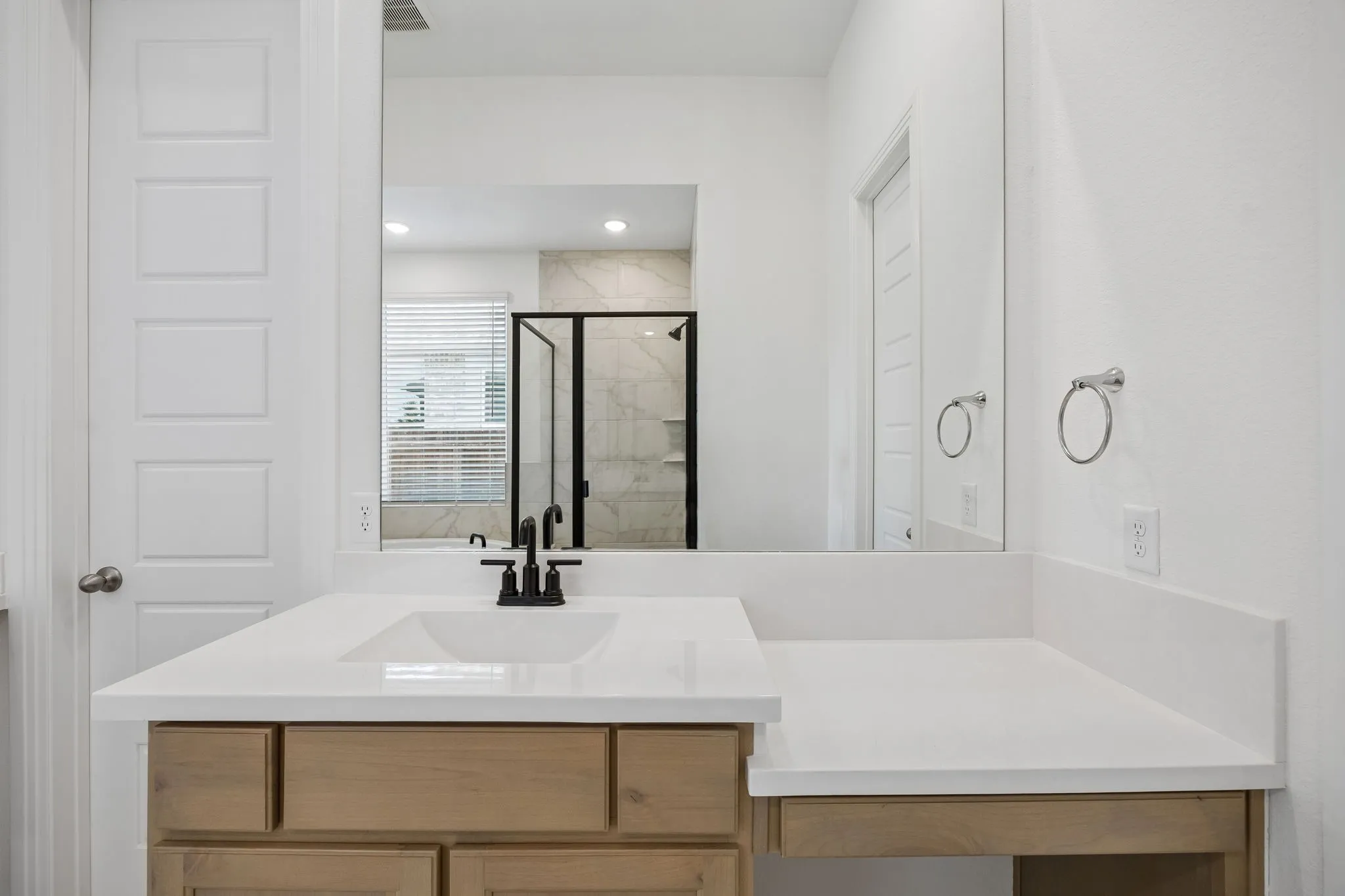 Primary Bathroom featuring a wall-mounted shelf, white walls, and a panel door