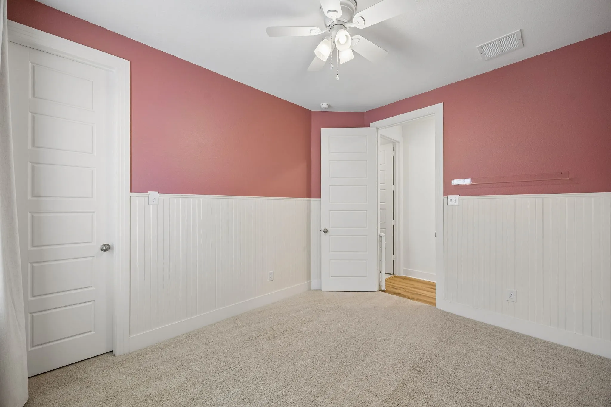 Secondary Bedroom #2 features White vanity with a single basin, black faucet fixtures, and a large mirror