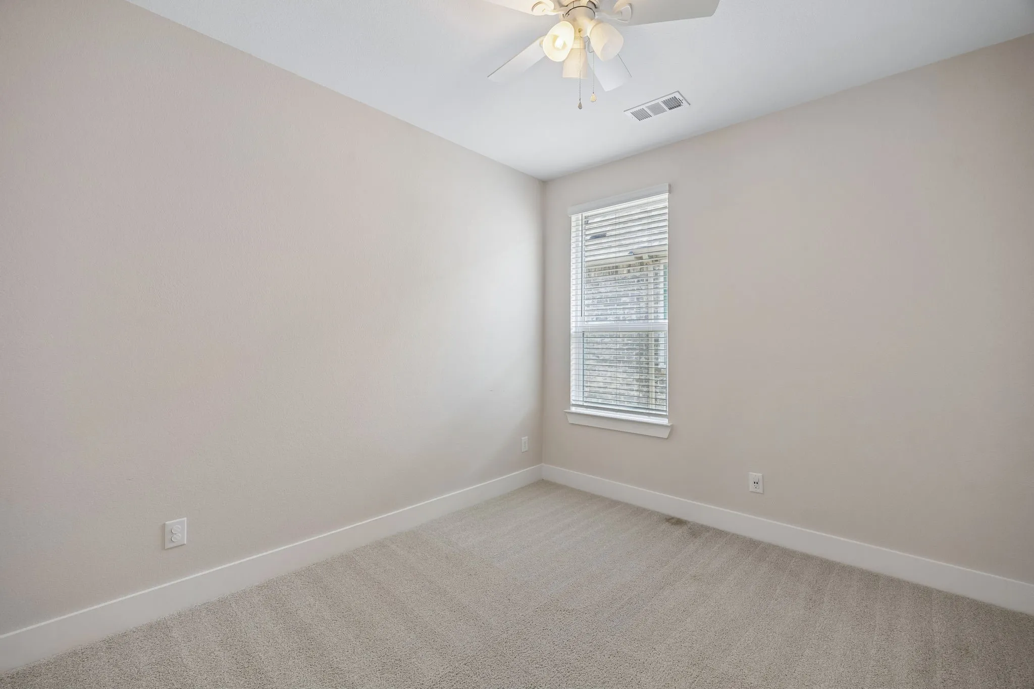 Secondary Bedroom #3 features Light beige carpeting