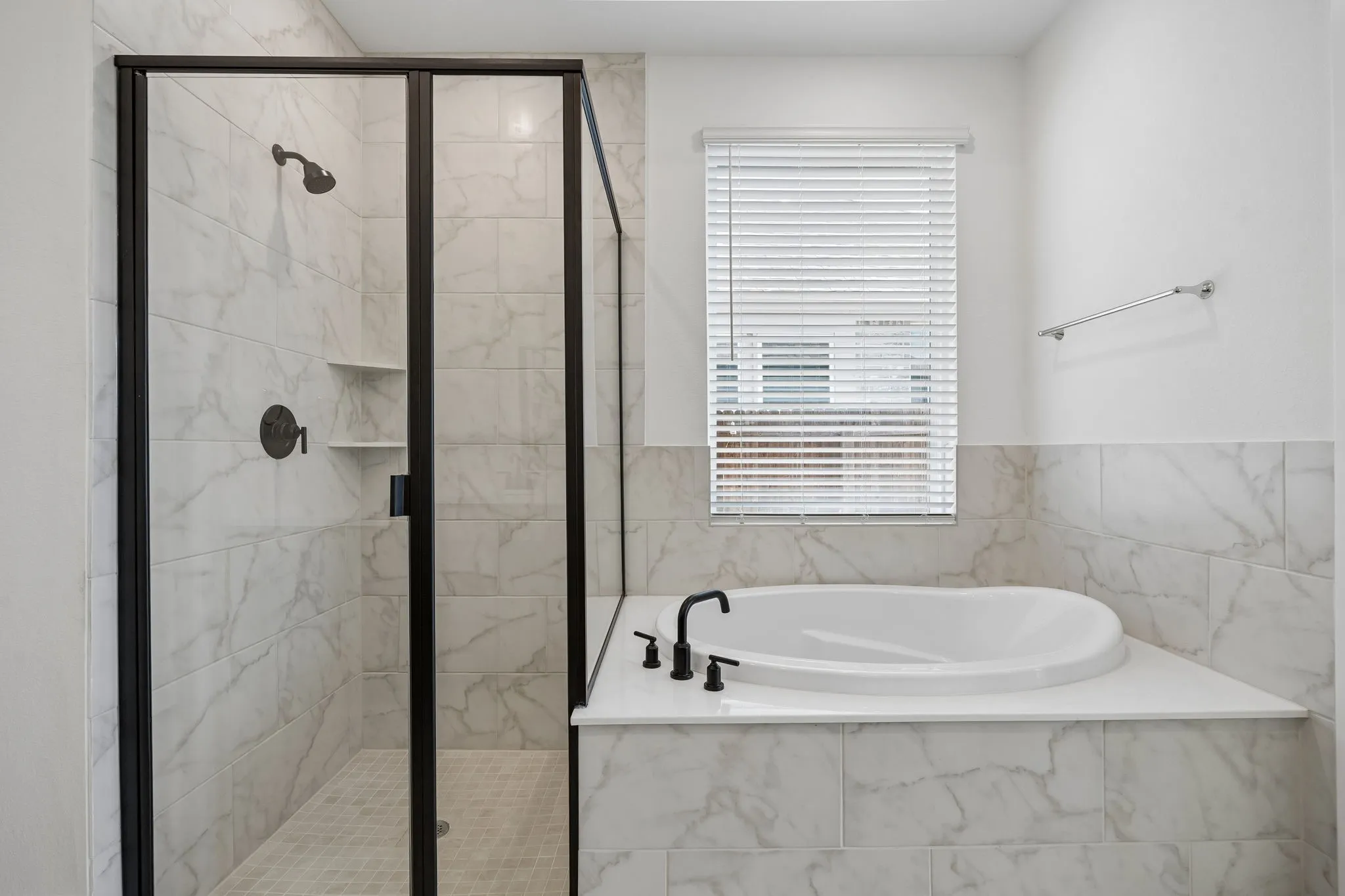 Primary Bathroom featuring Carpeted walk-in closet with built-in shelving and chrome hanging rods