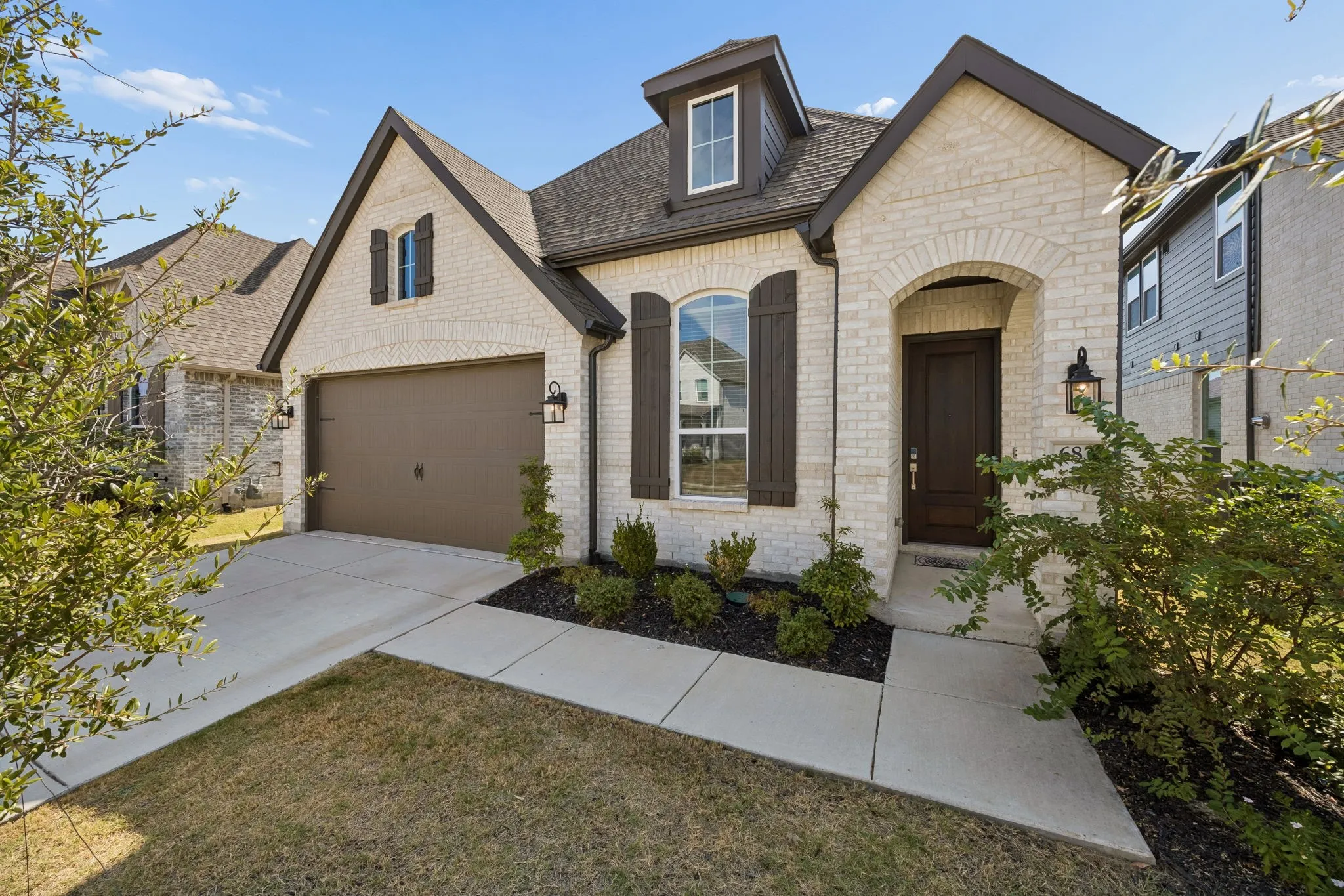 Open-concept living space with wood-finish flooring, vaulted ceiling, and recessed lighting