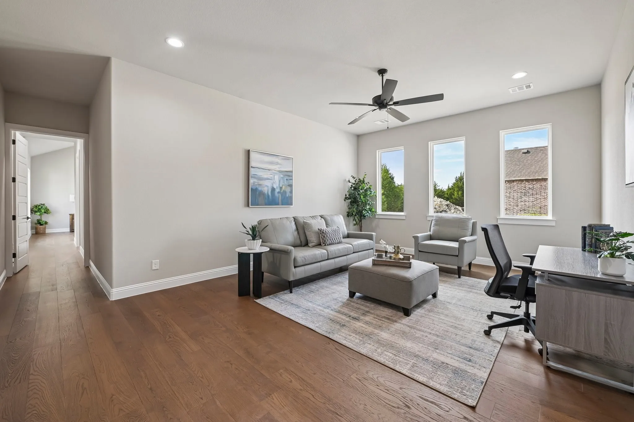 Wood-finish flooring, recessed lighting, and a ceiling fan