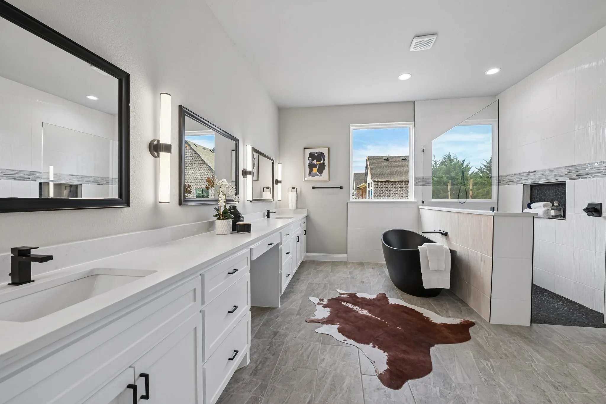 Expansive vanity with dual integrated sinks and white cabinetry