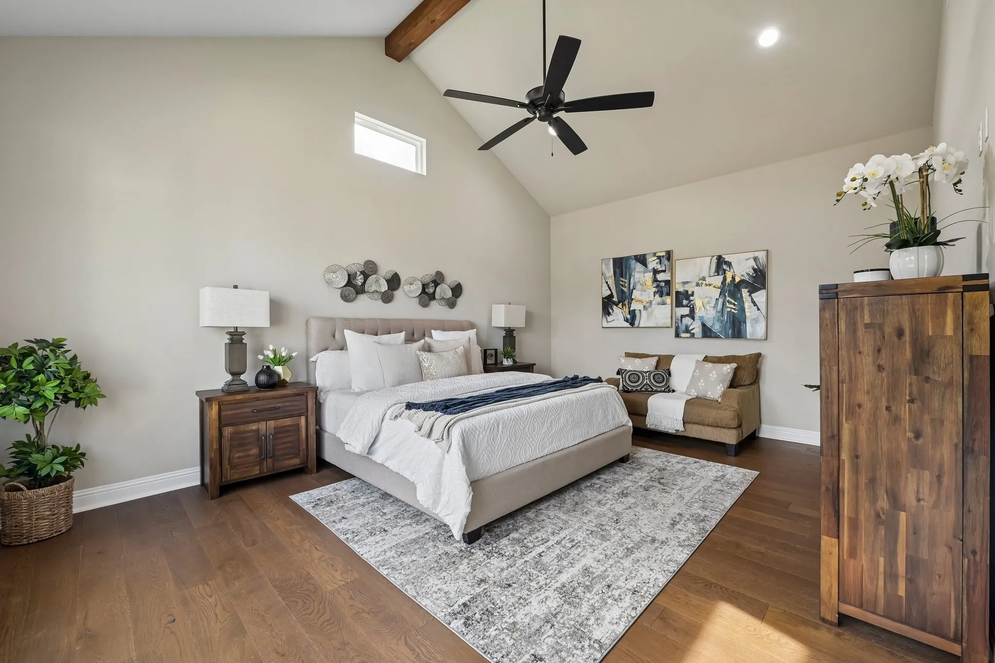 Vaulted ceiling with exposed wood beam, wood-finish flooring, recessed lighting, ceiling fan, and high accent window