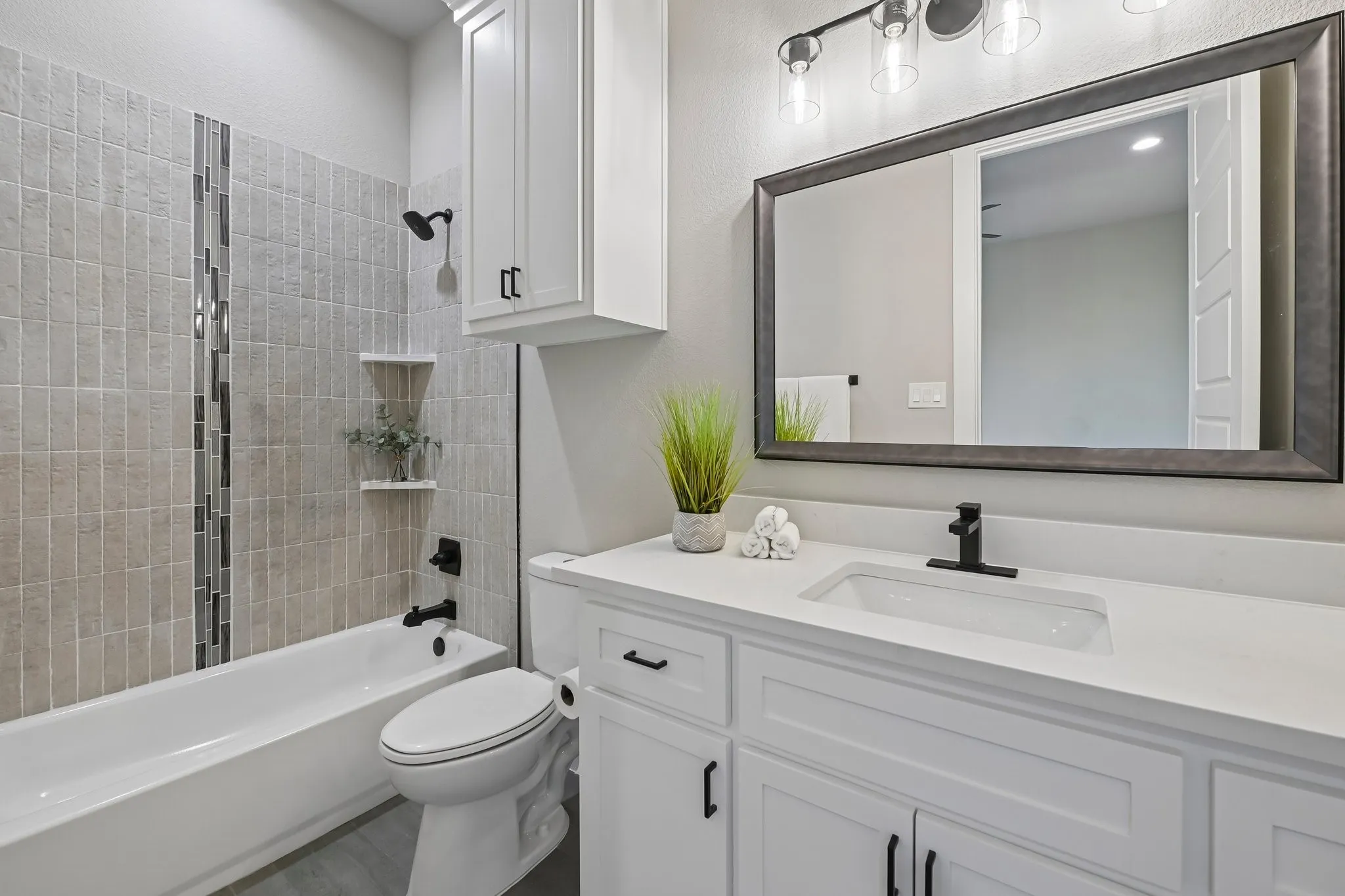 White vanity with shaker-style cabinetry, a white countertop, and a rectangular undermount sink