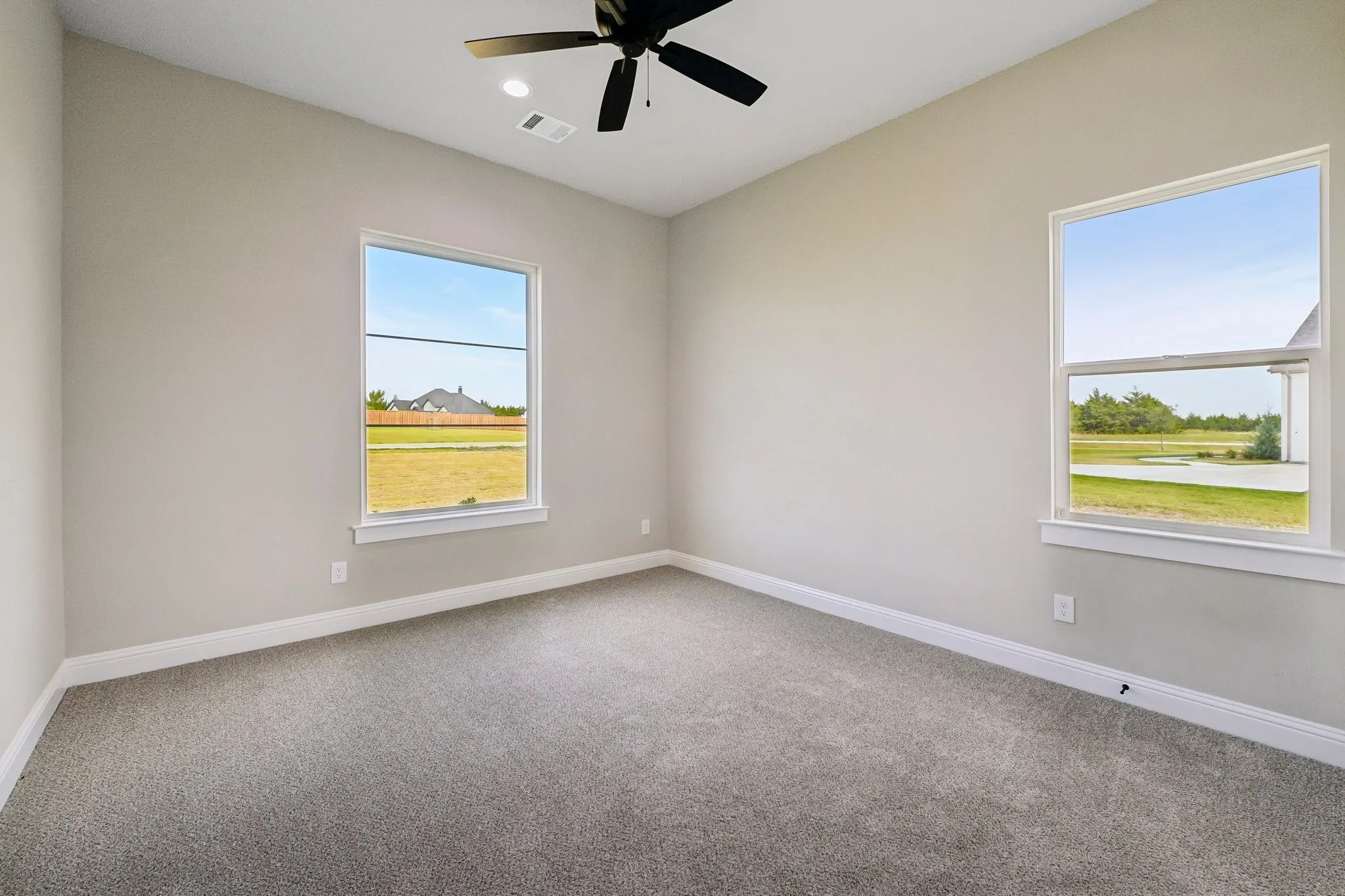 Neutral-toned walls and grey carpeting