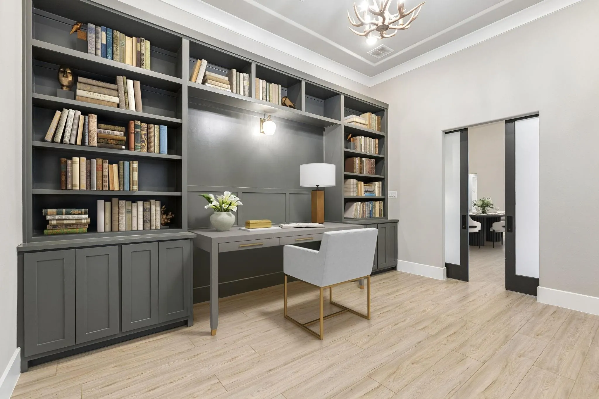 Built-in shelving with lower cabinetry, wood-finish flooring, coffer ceiling, recessed lighting, and pocket doors
