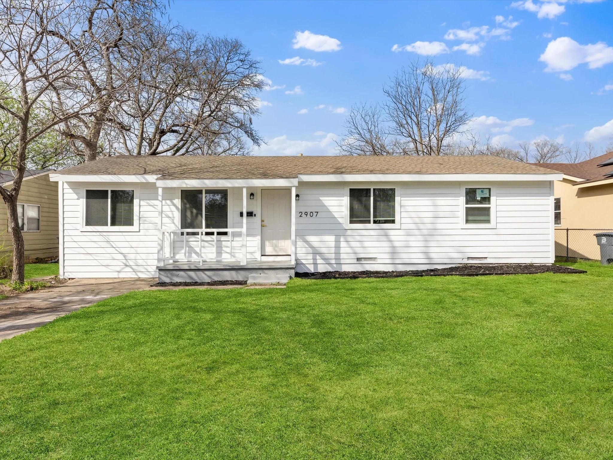White siding exterior with a covered entry