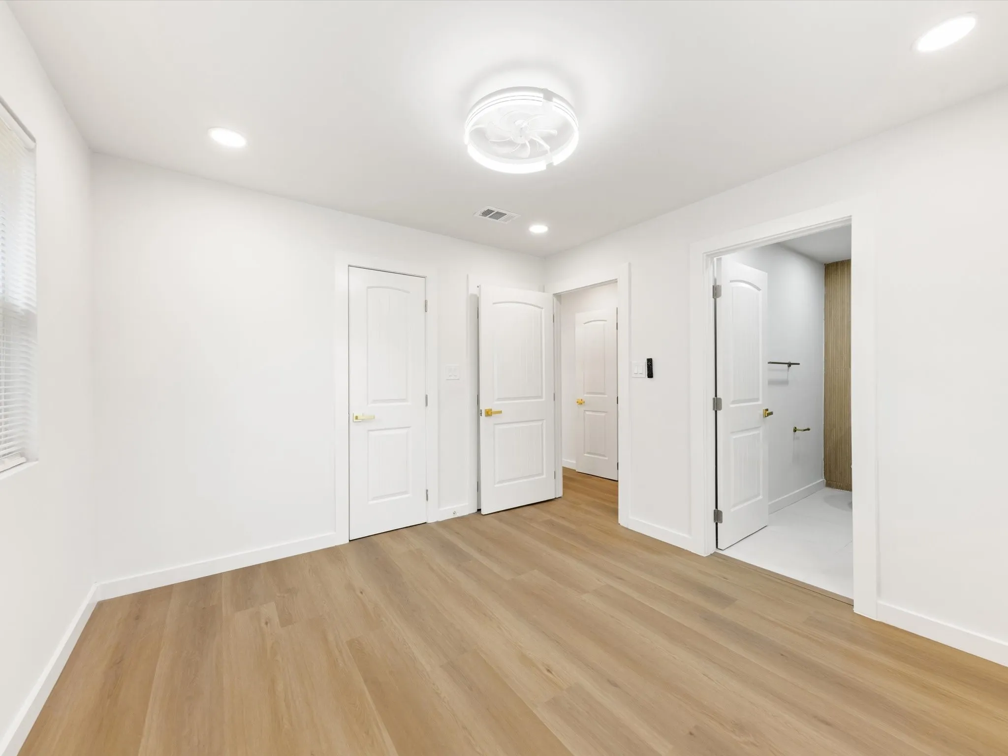 Light wood-finish flooring, recessed lighting, and a modern ceiling fan