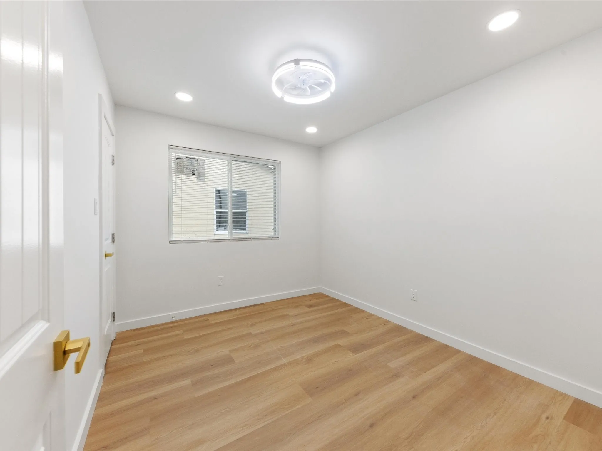 Wood-finish flooring, recessed lighting, and a modern ceiling fixture