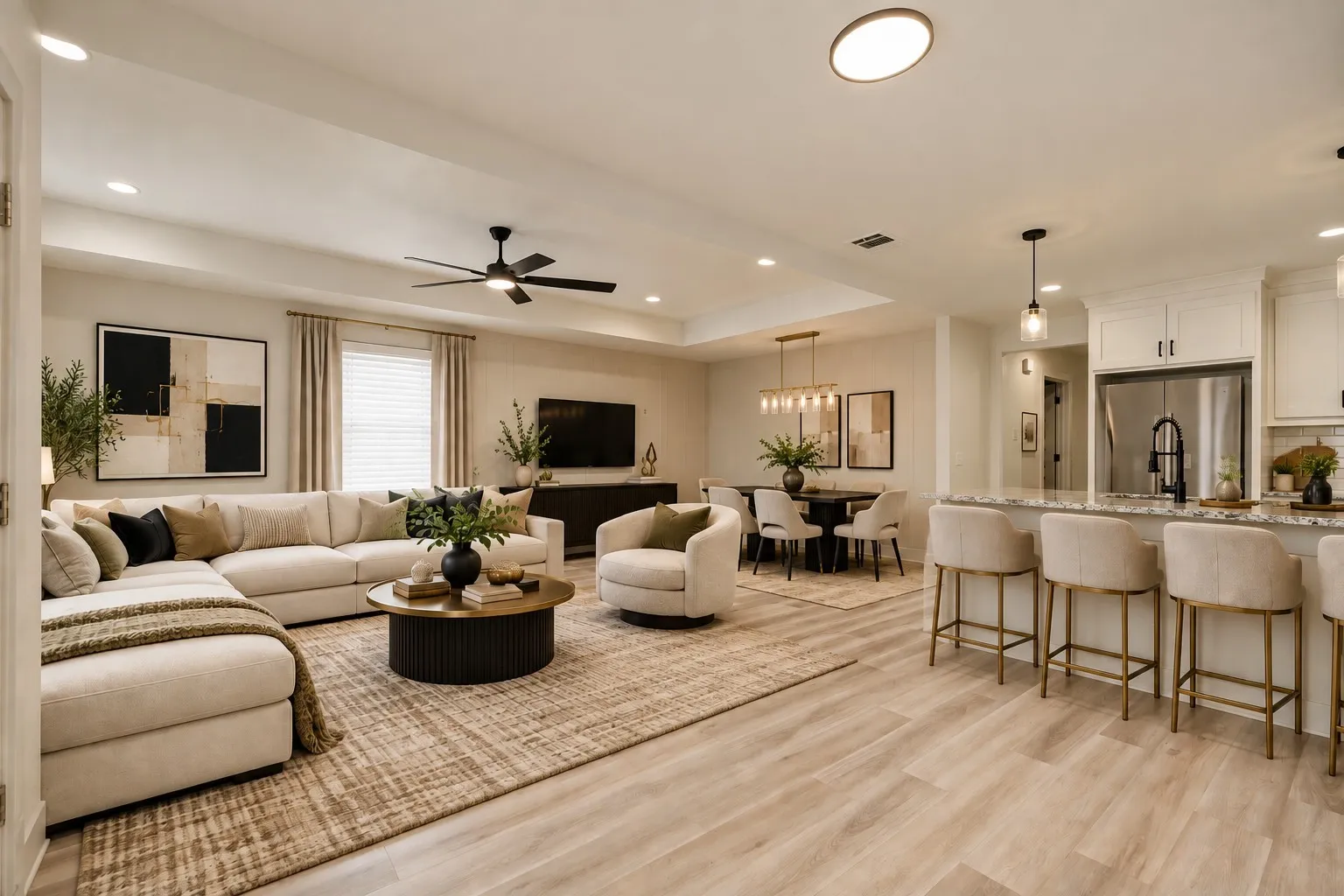 Open-concept living area featuring wood-finish flooring, recessed lighting, a ceiling fan, a kitchen island with pendant lighting, and white cabinetry