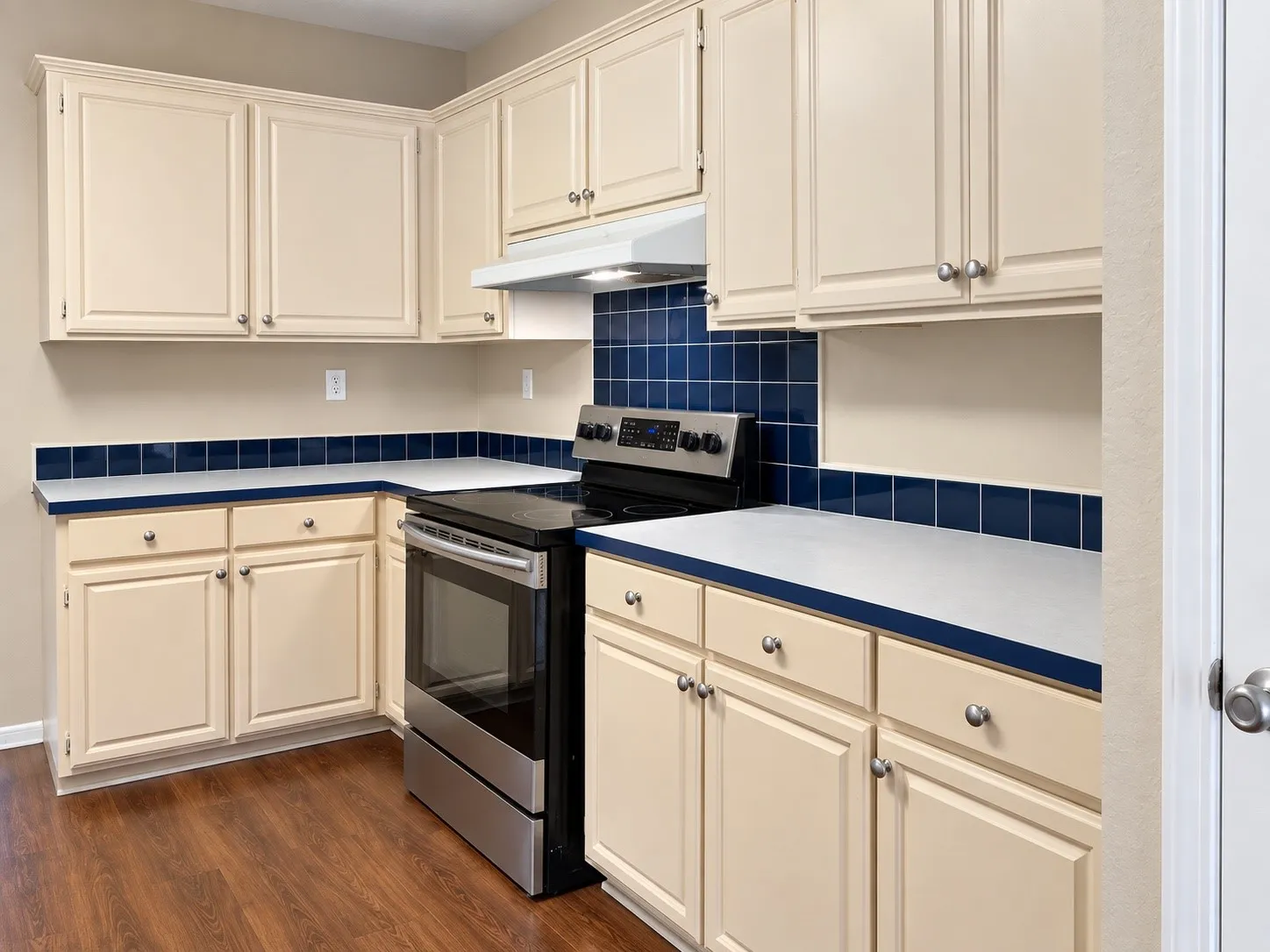 Wood-finish flooring with a full suite of stainless steel appliances