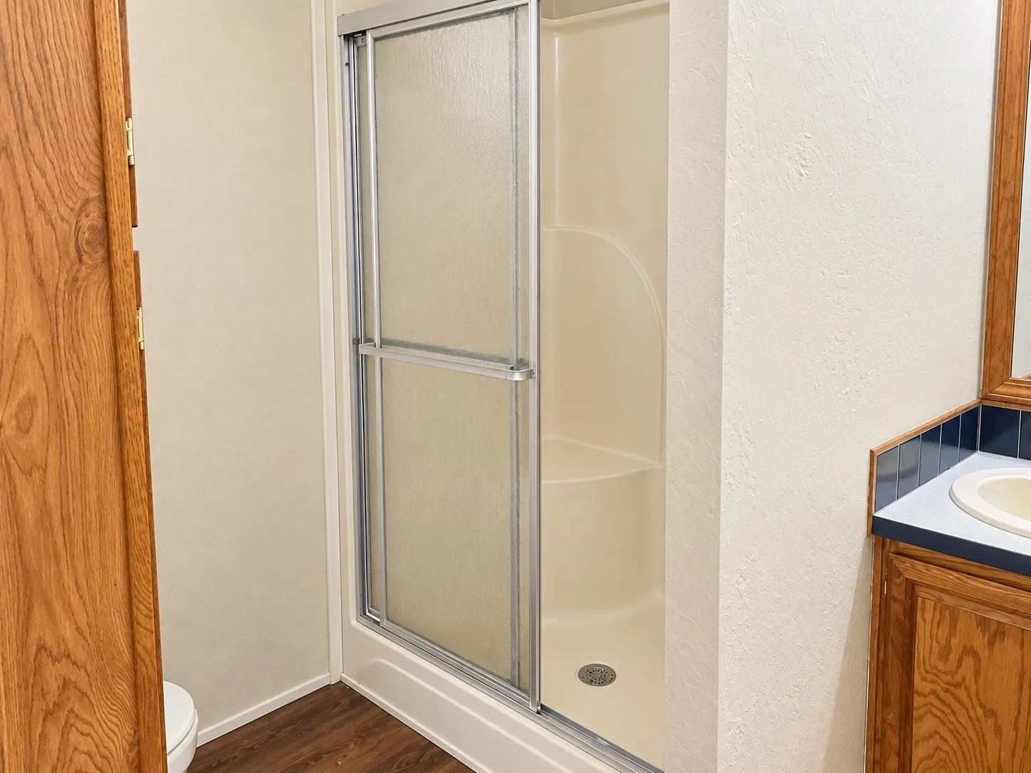 Enclosed shower with sliding glass doors