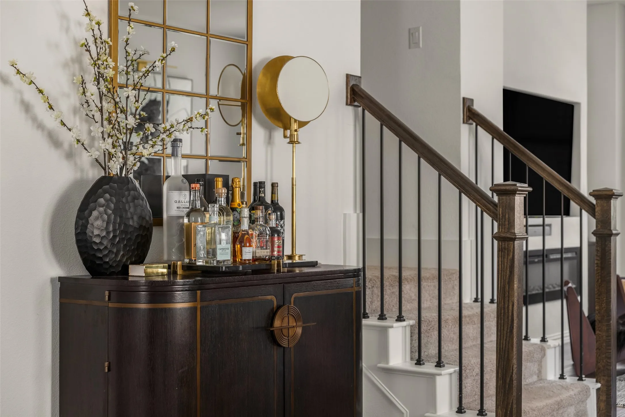 Dark wood-finish cabinetry featuring brass accents