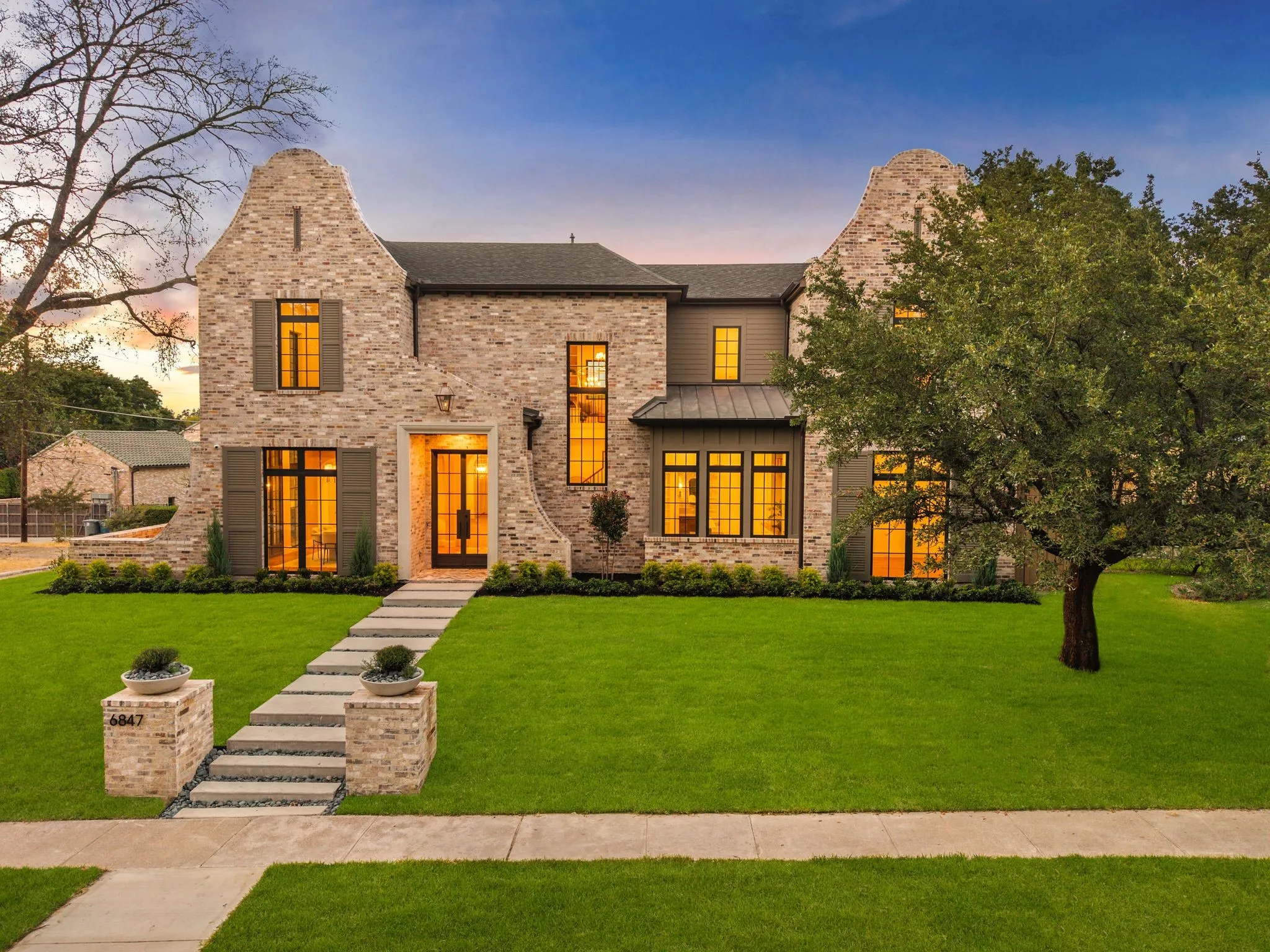 Stately stone-clad exterior with prominent gables and dark-framed windows