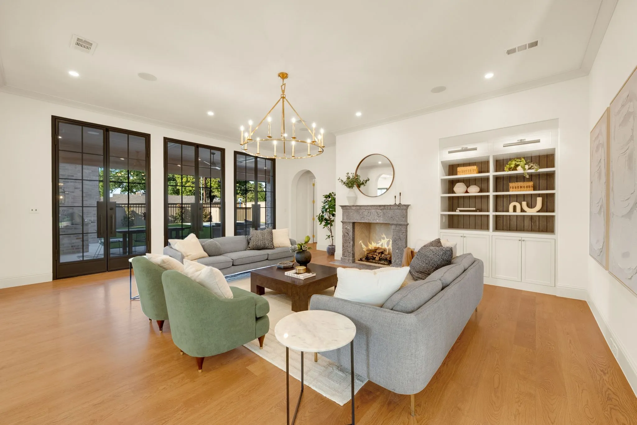Bright living area featuring wood-finish flooring and a decorative chandelier