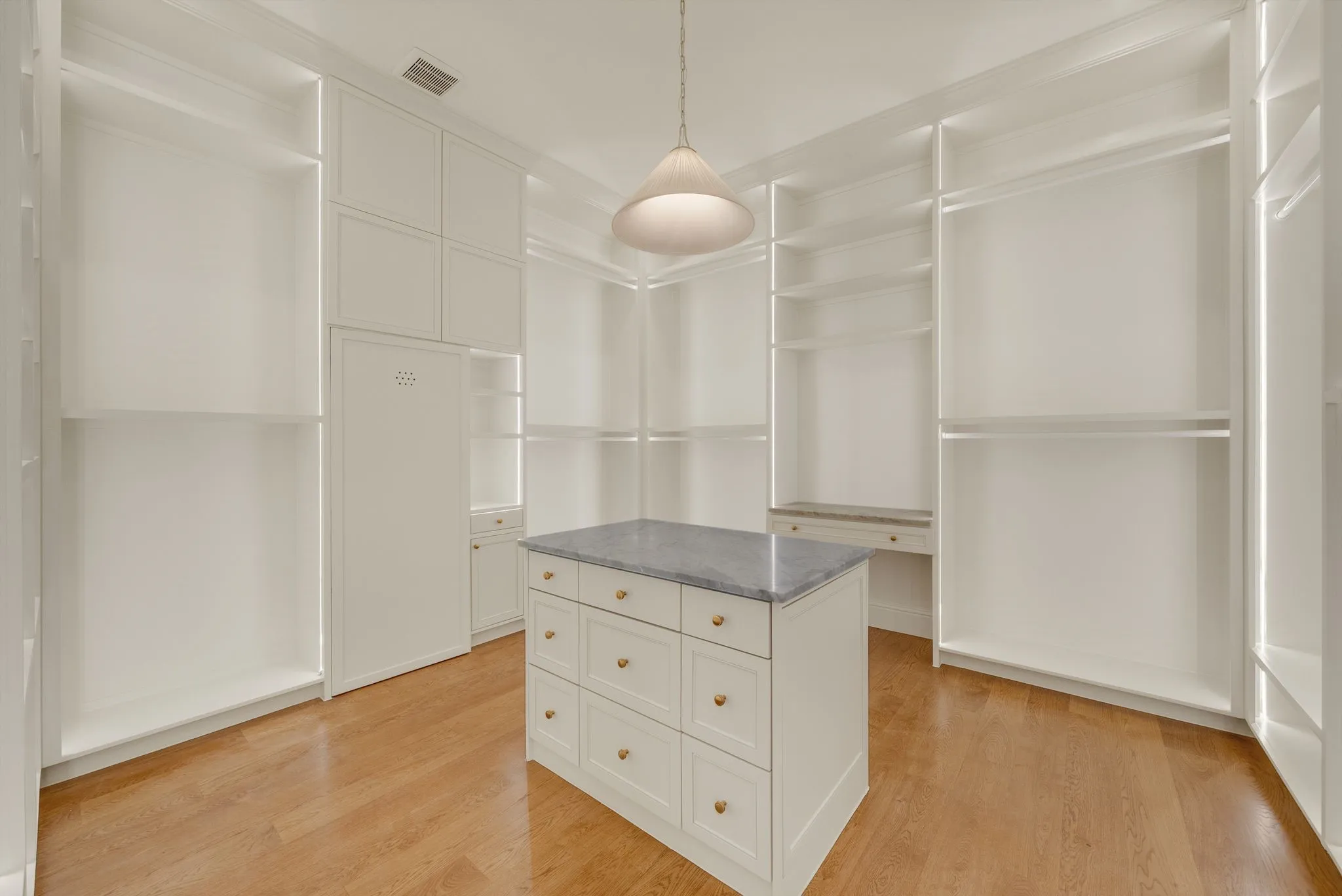 Built-in cabinetry with open shelving and hanging rods
