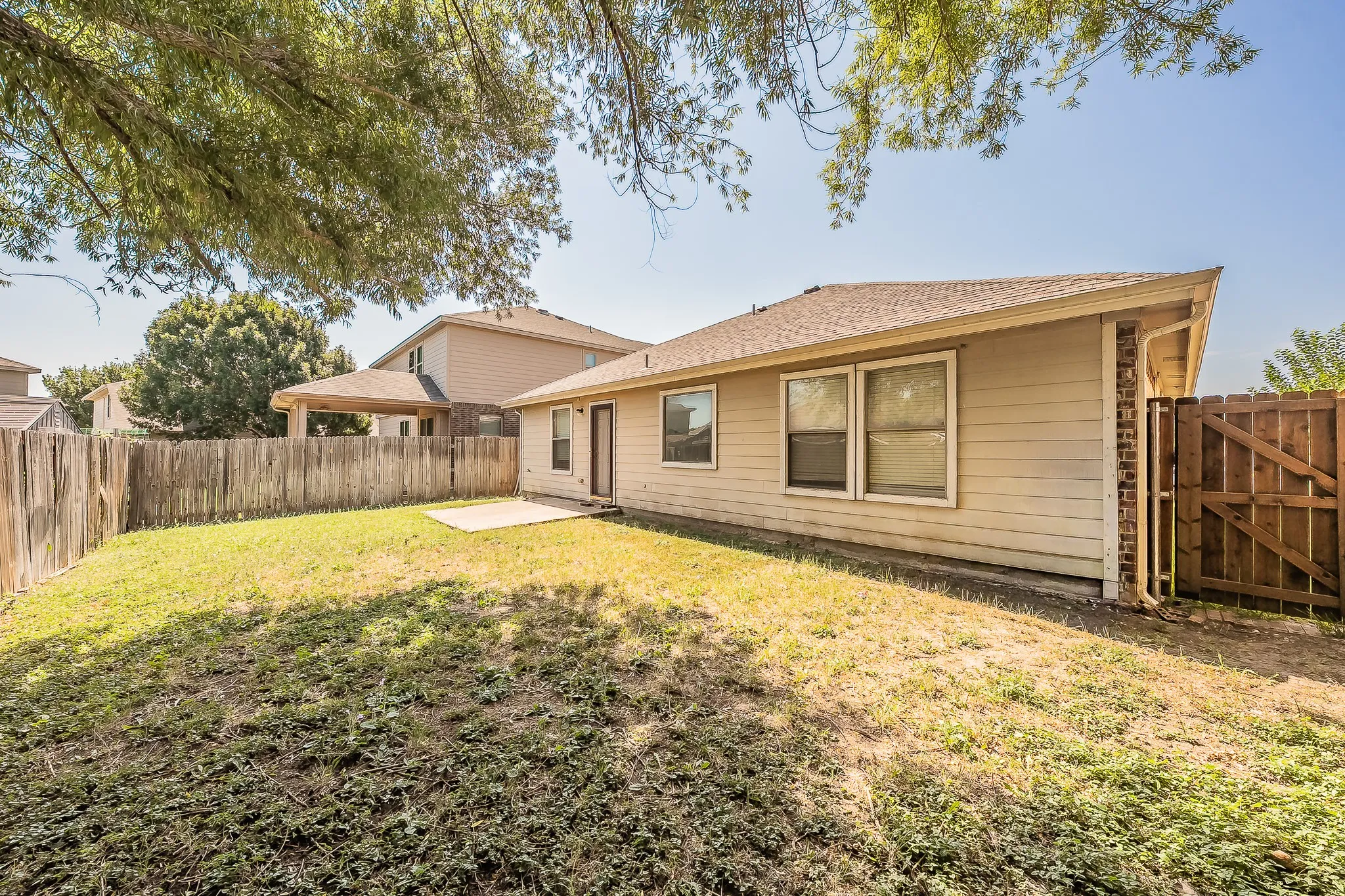 Spacious single-story residence with a generous backyard featuring mature landscaping and established trees