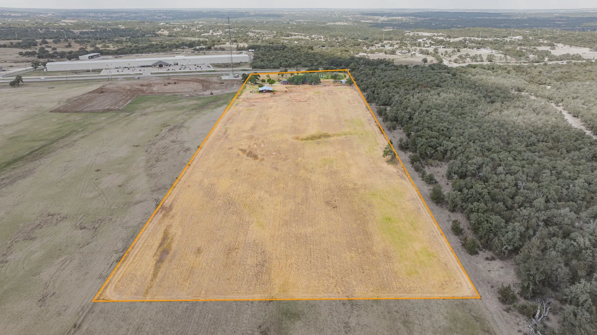 Expansive lot featuring open land and a perimeter of mature trees