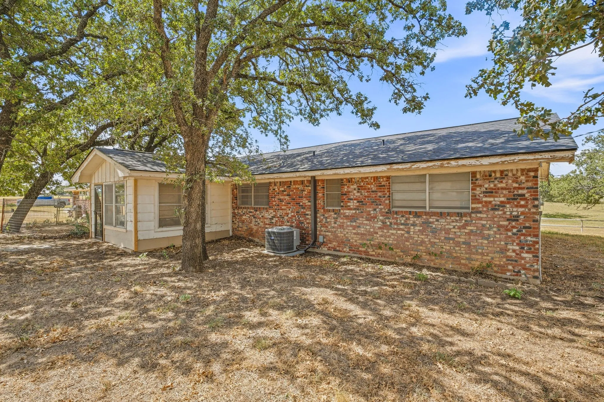 Brick and siding exterior with a dark shingle roof
