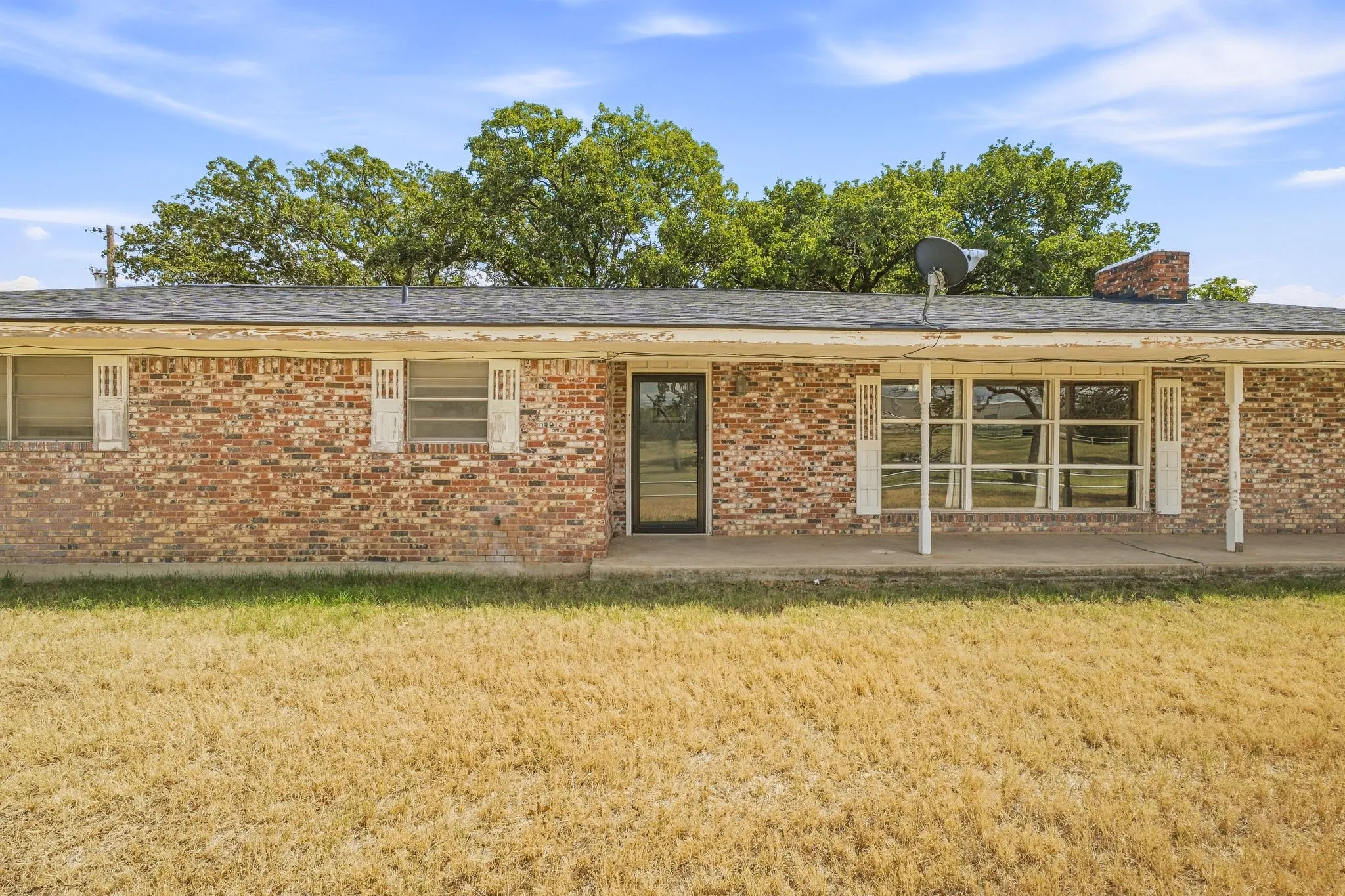 Brick exterior with a covered porch