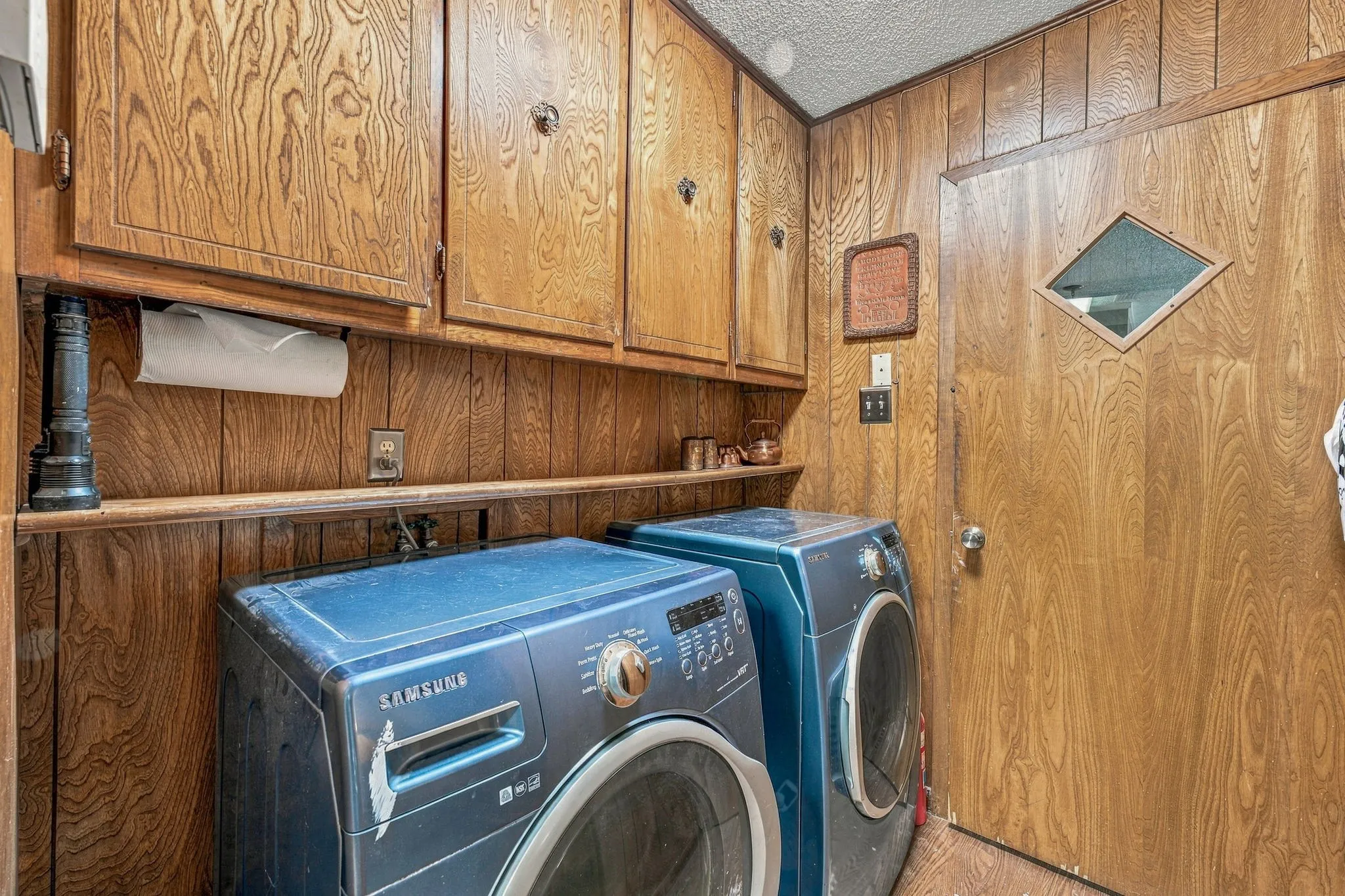 Wood-paneled walls and matching upper cabinetry
