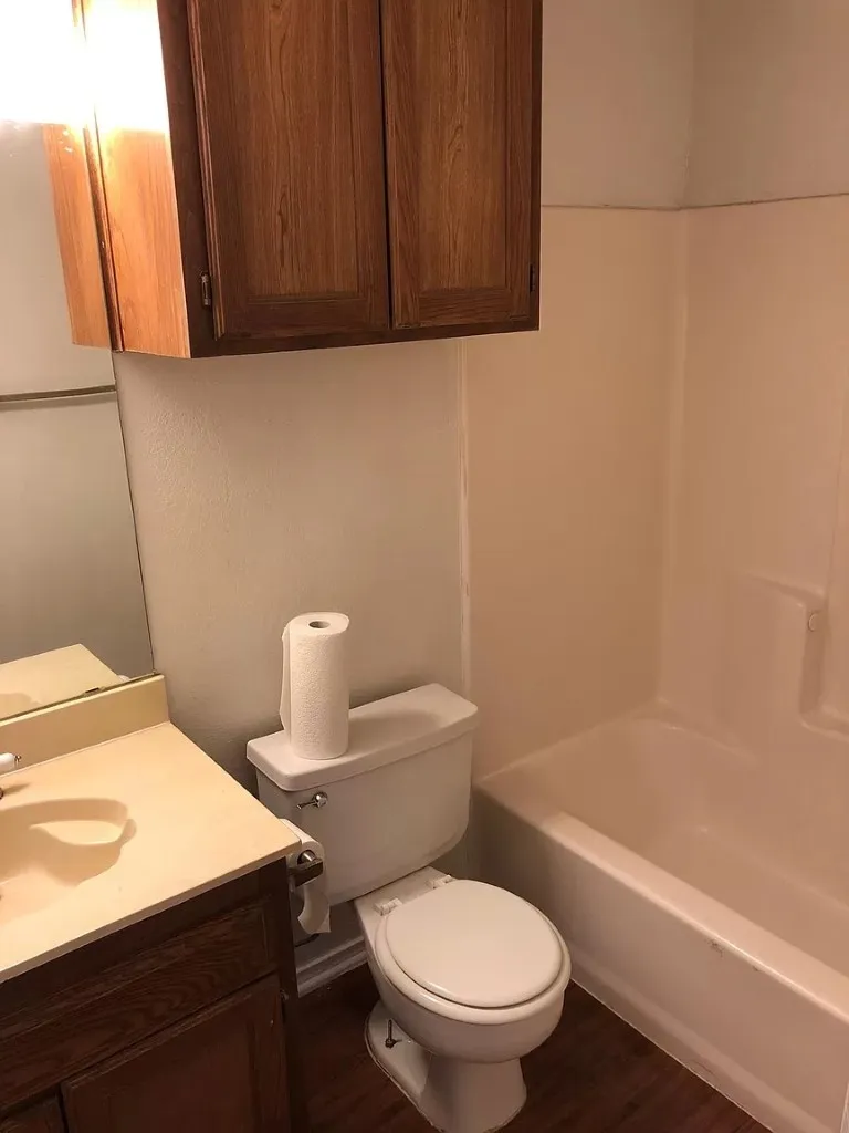 Built-in wood-finish cabinetry and matching wood-finish vanity