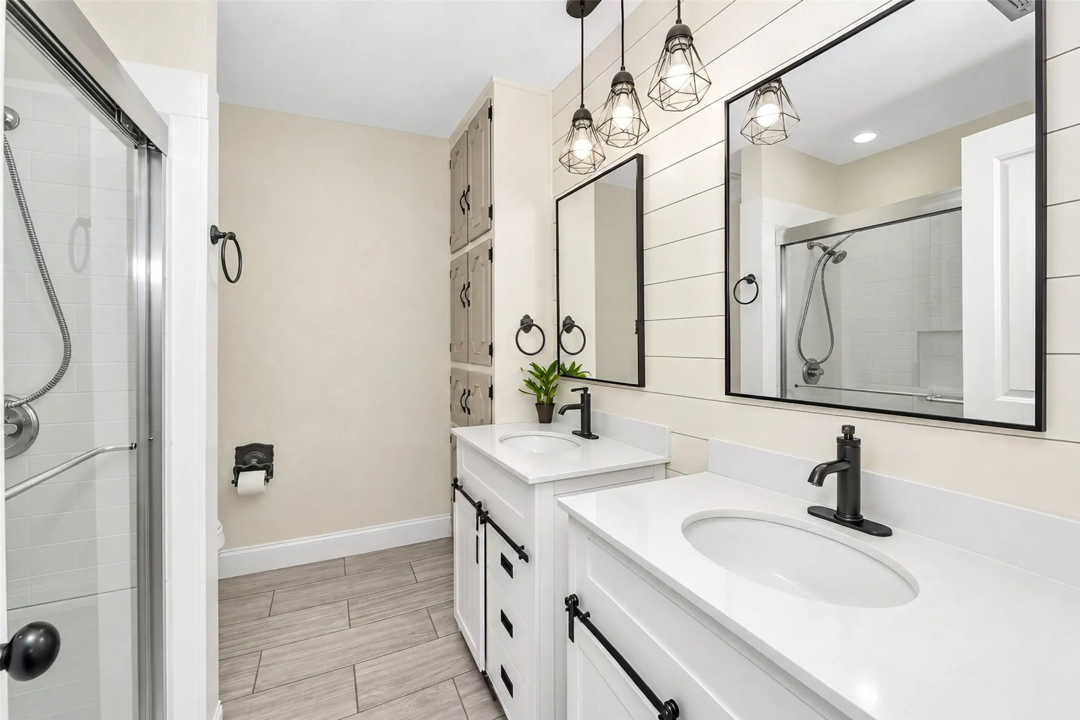 Dual vanity with white cabinetry and solid surface countertops