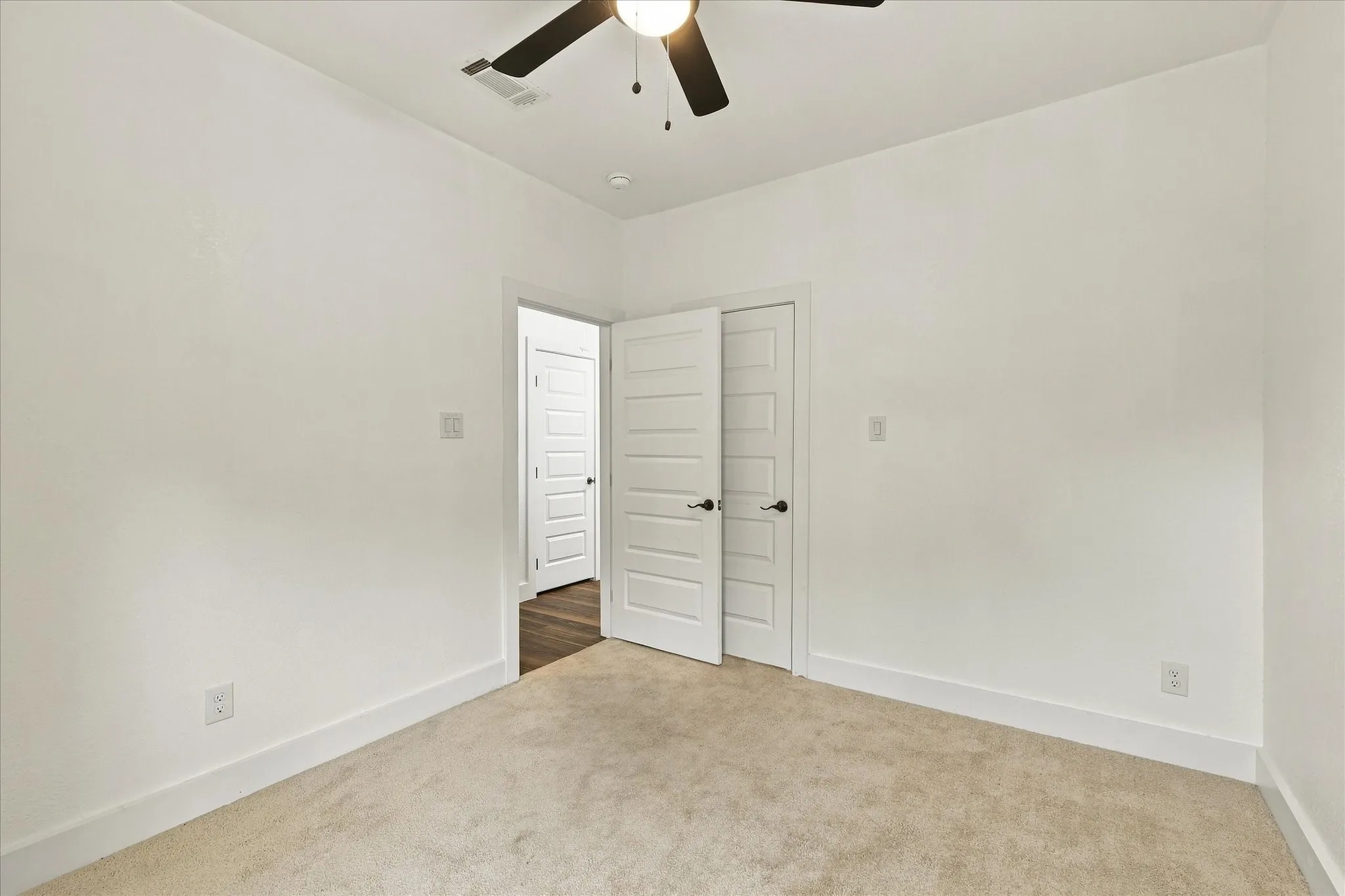 Neutral paint colors throughout, ceiling fan with integrated lighting, and white trim