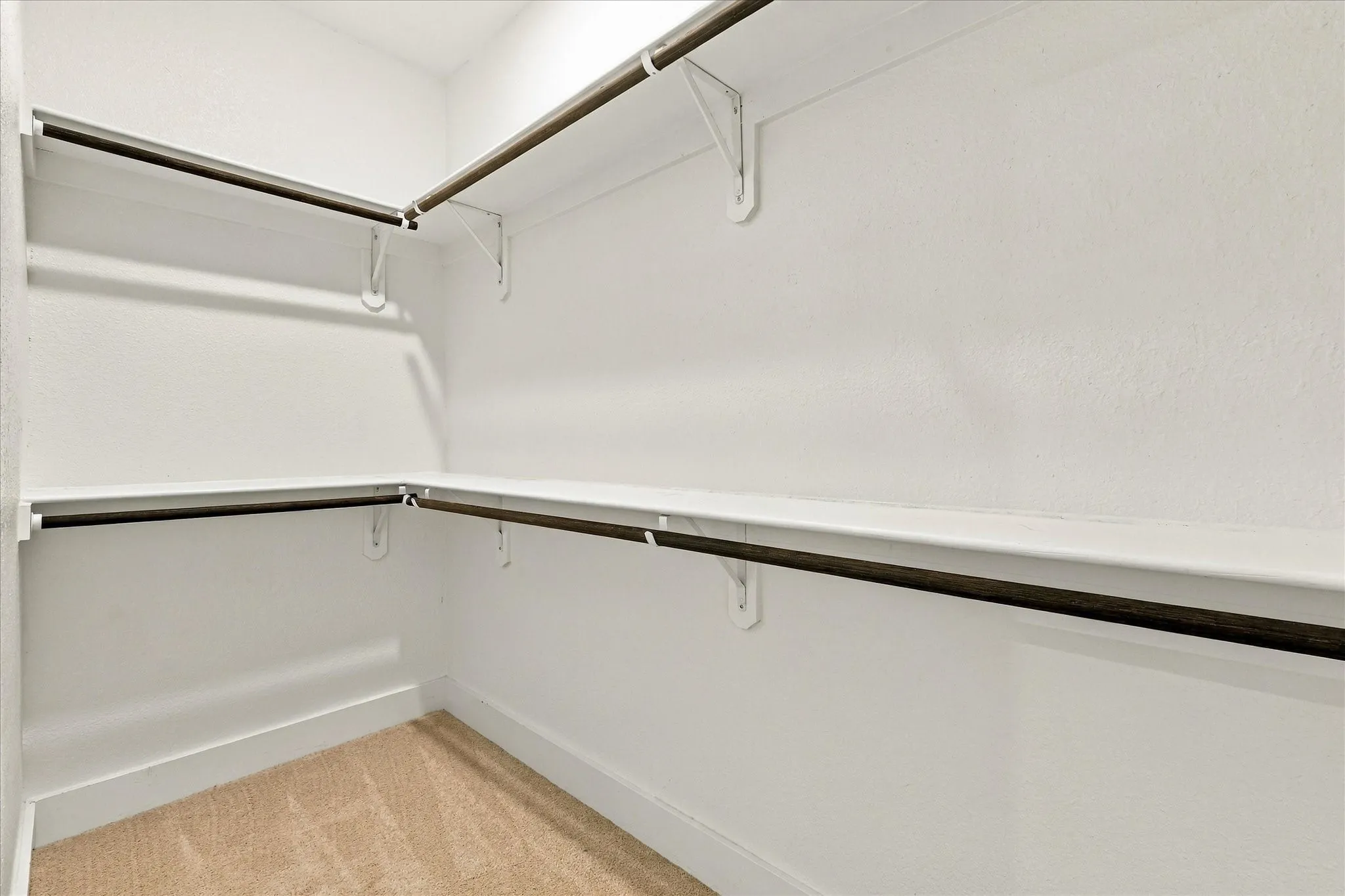 Walk-in closet with ample shelving and hanging rods