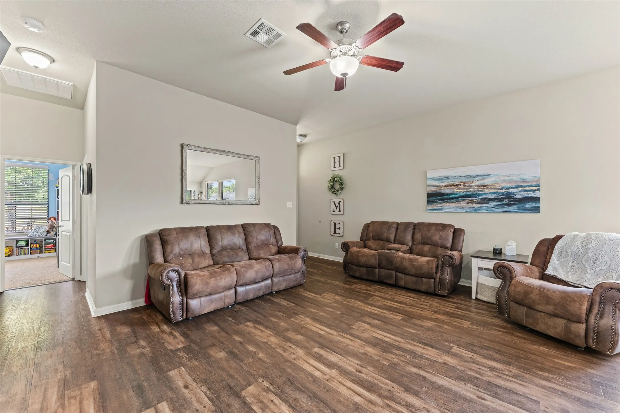 Wood-finish flooring throughout, ceiling fan with integrated lighting, recessed lighting, and neutral wall tones