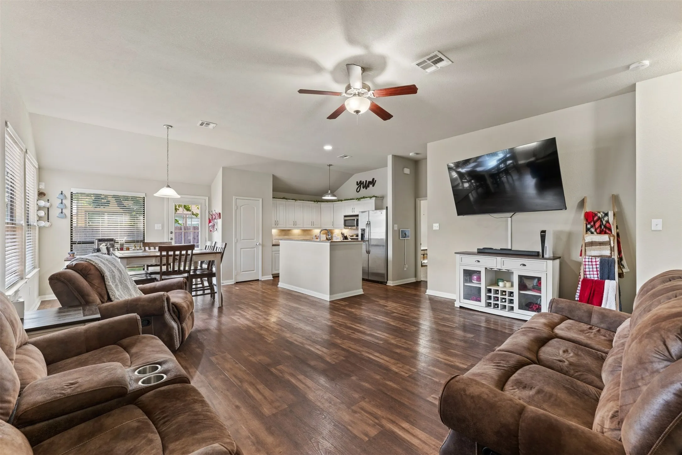 Wood-finish flooring, vaulted ceilings, and a ceiling fan