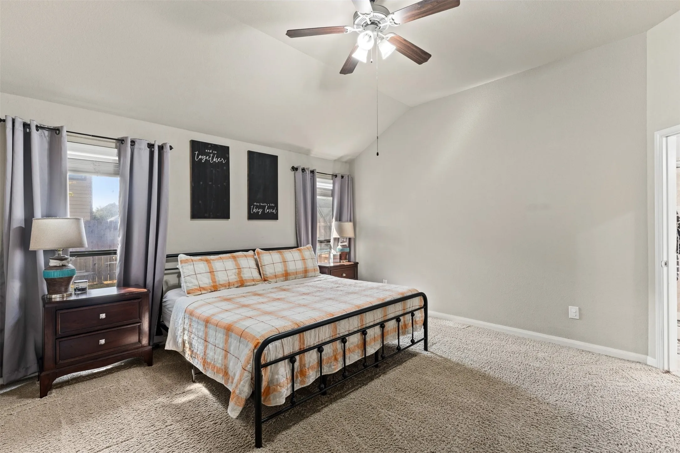Vaulted ceiling featuring a ceiling fan with integrated lighting