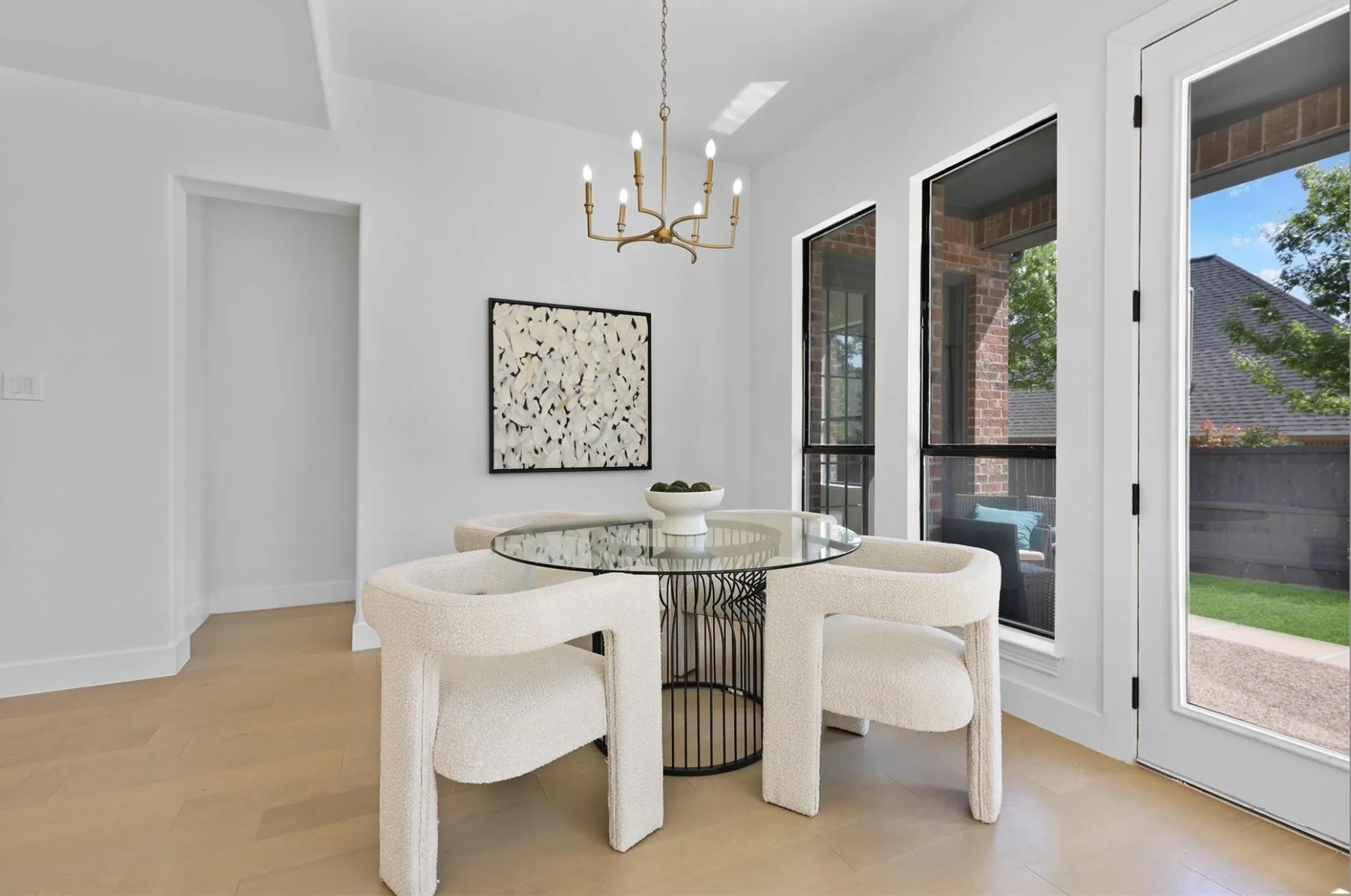 Light wood-finish flooring with crisp white walls