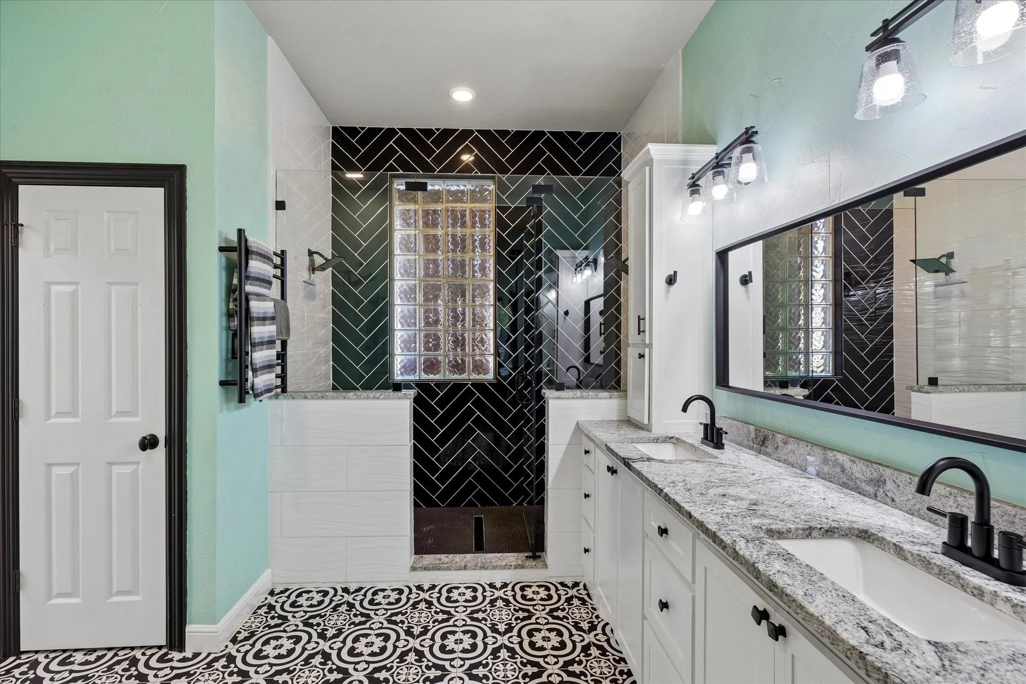 Dual vanity with stone countertops and undermount sinks