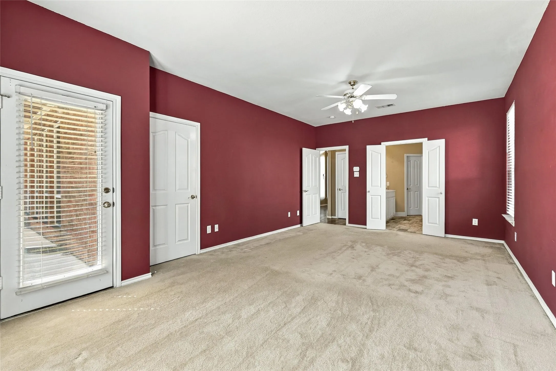 Primary bedroom  conveniently located downstairs with access to the backyard