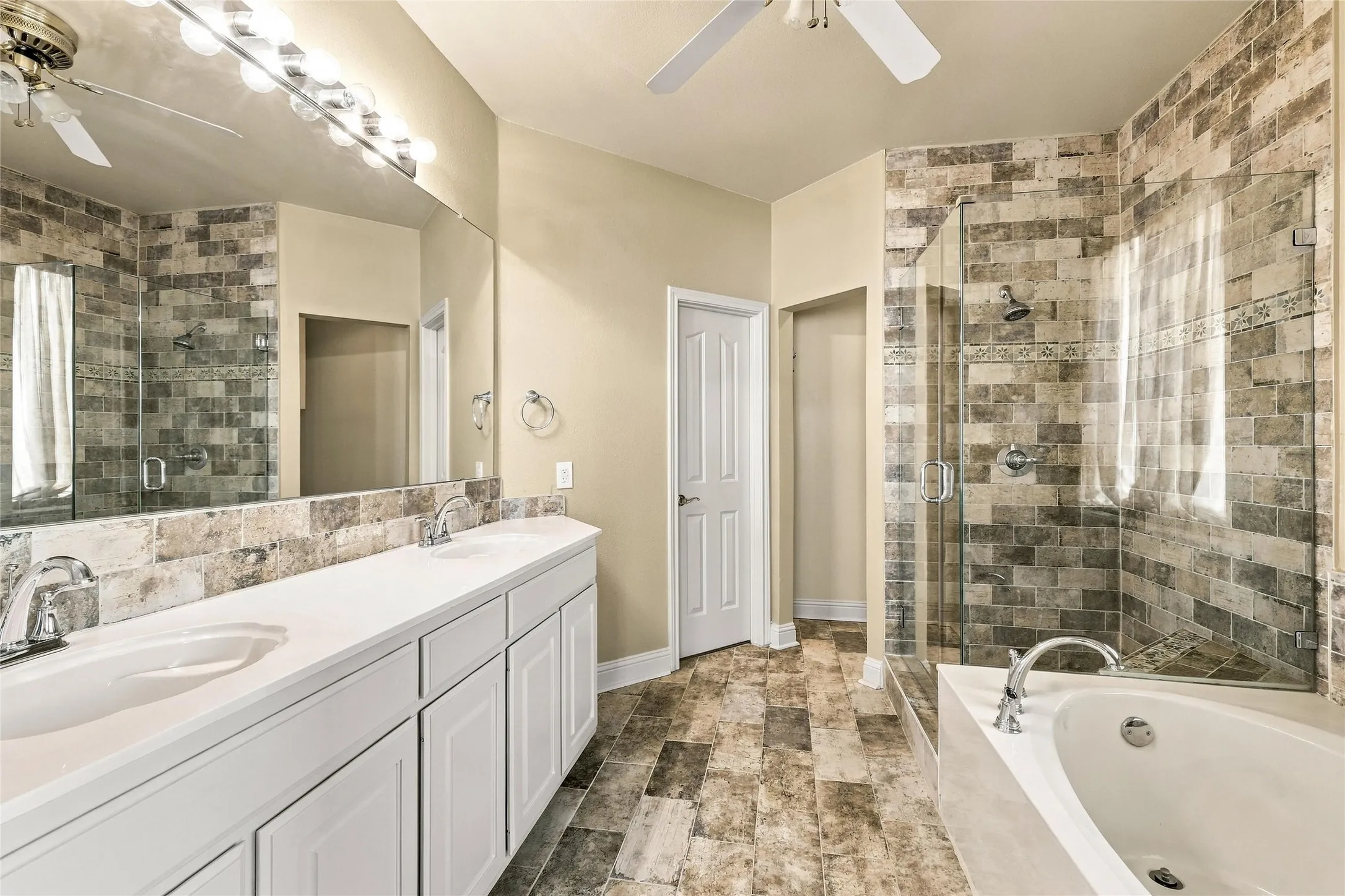 Primary bathroom is beautiful with large tub, dual sinks, walk in shower.
