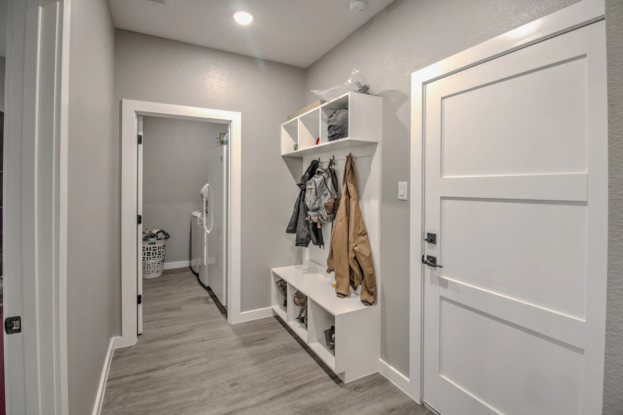 Come in from the garage into the convenient mud room, perfect to drop shoes or hang back packs/coats.