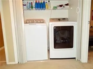 Laundry closet upstairs between the two rooms in hallway featuring built-in wire shelving and bi-fold doors
