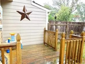 Wood-finish deck with matching wood railings and a wood privacy fence