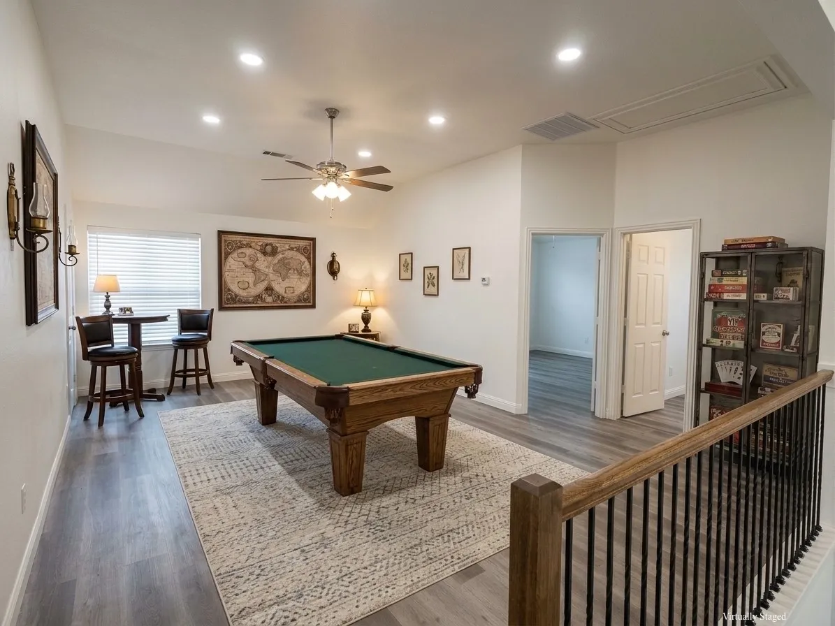 Vaulted ceiling game room featuring recessed lighting, wood-finish flooring, a ceiling fan, and a wood and metal railing - VIRTUALLY STAGED